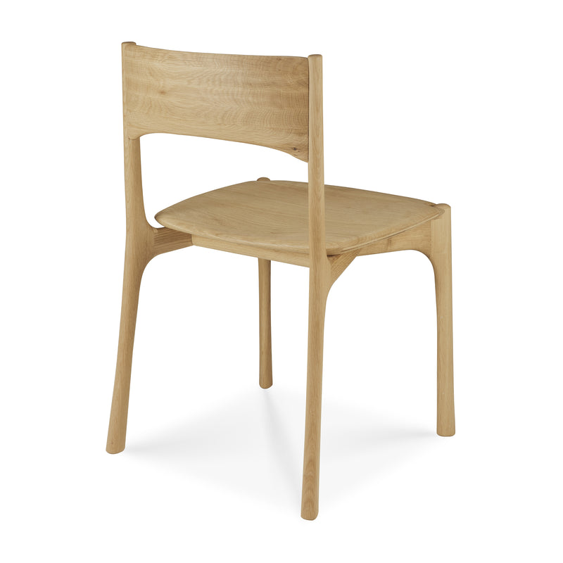 Pi Dining Chair made of handcrafted oak with sleek, natural curves and a polished imperfect finish.