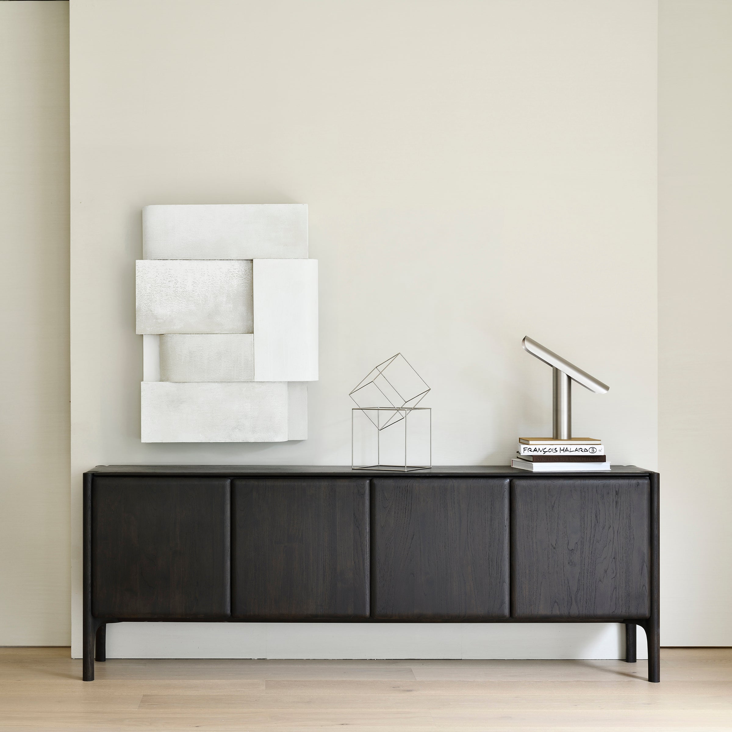 Pi Sideboard in dark varnished teak oak with four doors, minimalist design, styled with modern decor items.