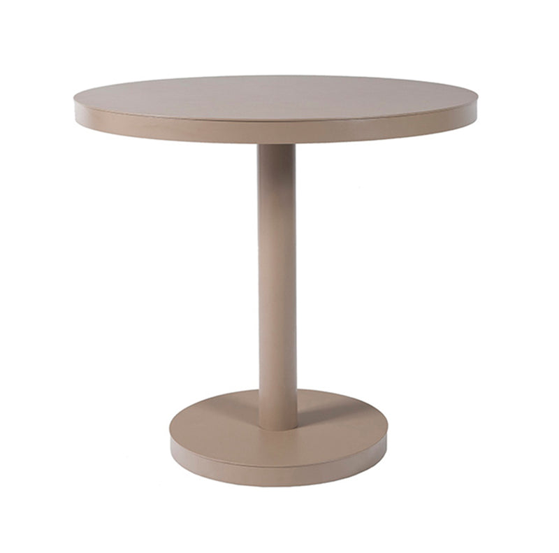 The Barcino Pie Central Round Table by Resol showcases a minimalist design with a smooth beige surface, single central support made of powder-coated aluminum, and a circular base, all against a plain white background.