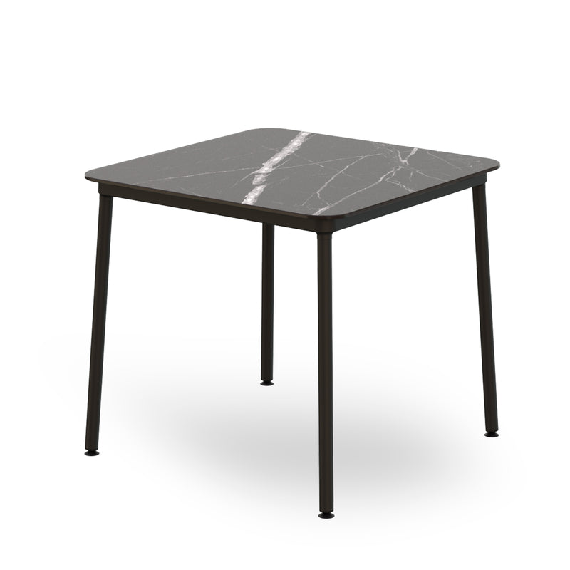The Resol Hub Table boasts an innovative design with a square dark marble top and sleek black legs.