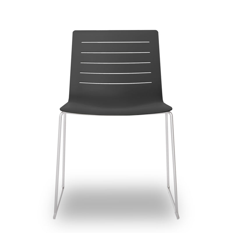 The Resol Skin Sled Chair is a modern, stylish addition to any sustainable furniture collection, featuring a black fiberglass and polypropylene seat with horizontal slits and sleek thin metal legs that enhance its minimalist design.