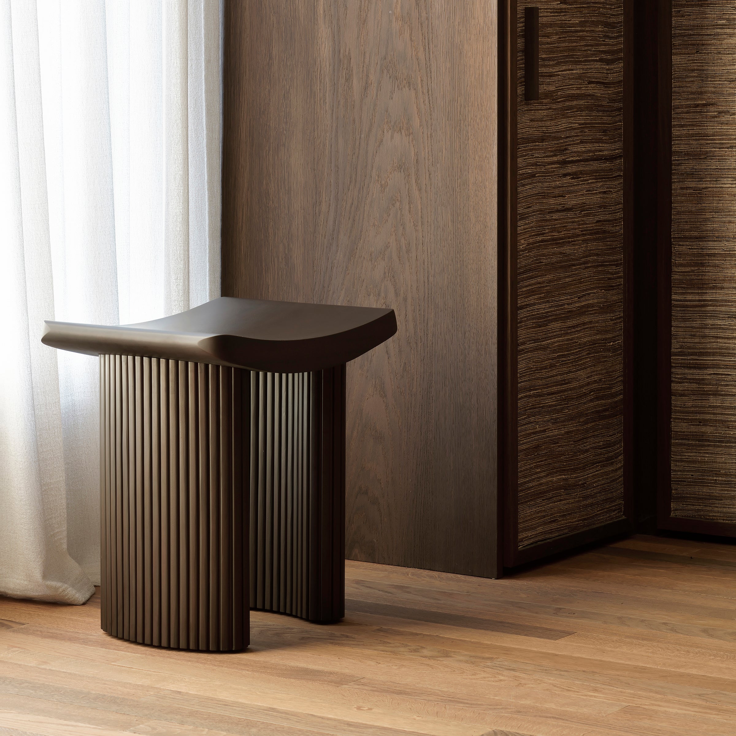 Roller Max Stool in varnished dark mahogany wood with stacked wood-stick design, compact and stylish seating option.