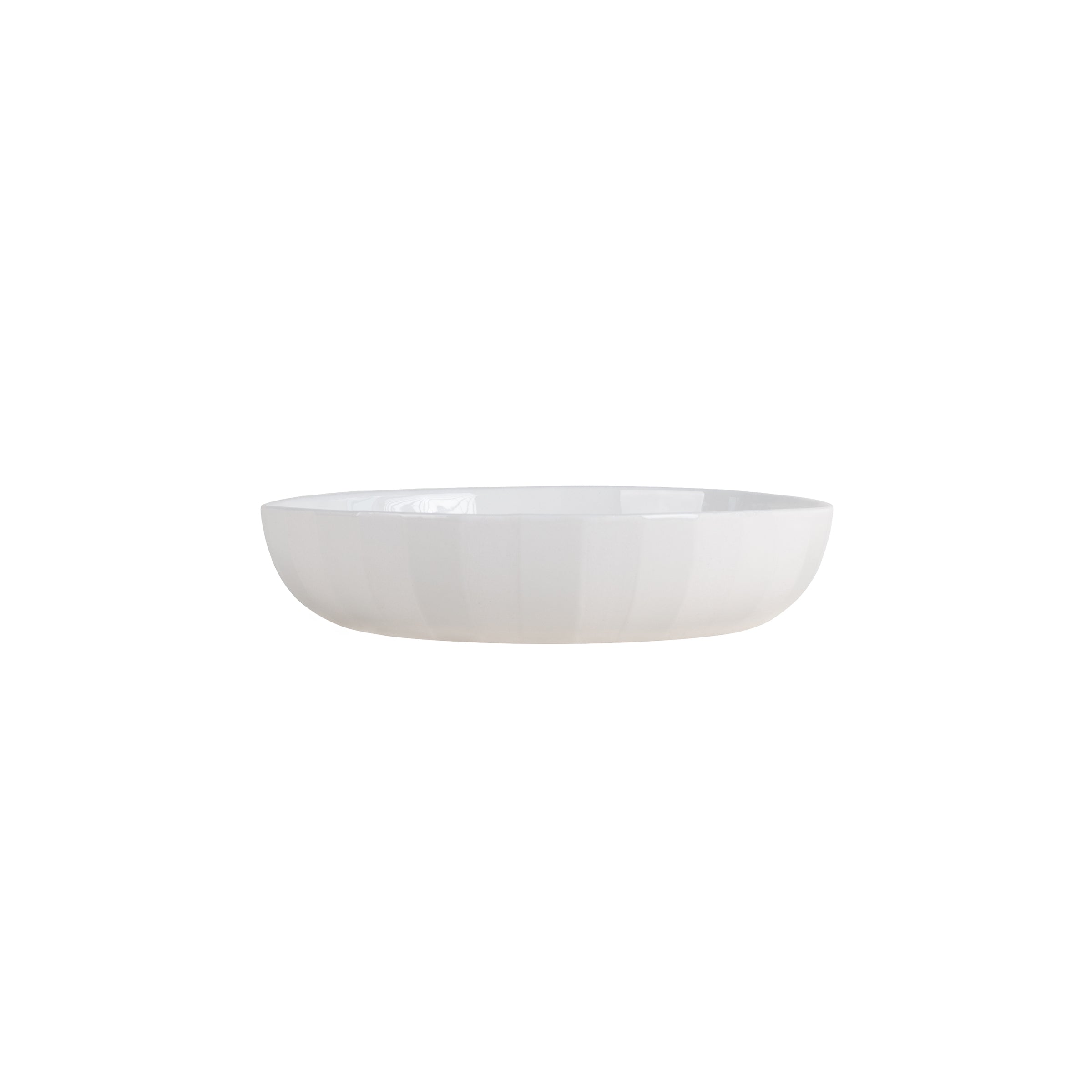 The Facet Tableware - Big Bowl by Schneid, a simple white ceramic piece with a round shape and slightly curved rim, is centered against a plain white background. It exudes minimalist elegance enhanced by subtle color dynamics in its smooth surface.
