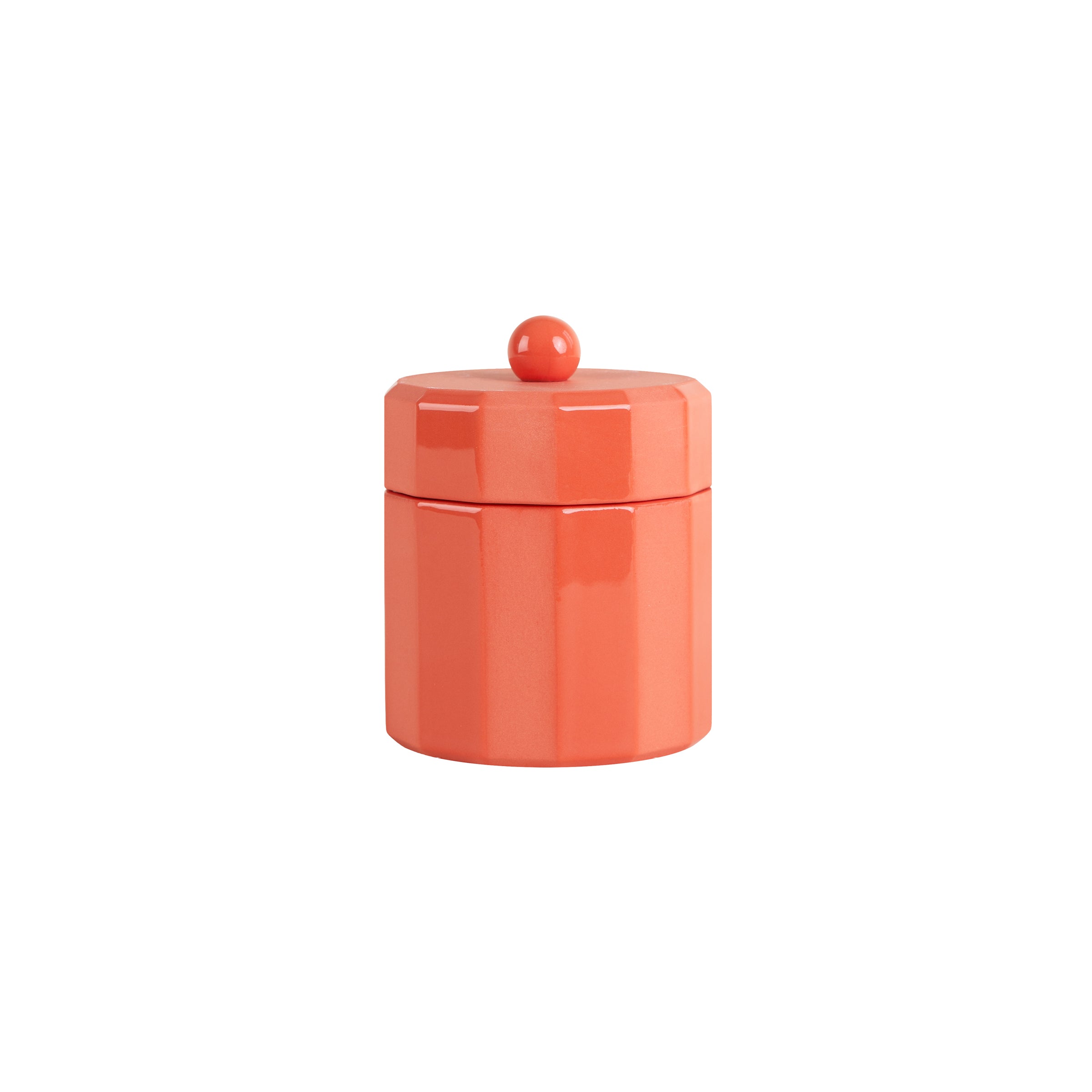 The Facet Tableware jar by Schneid is a small, orange ceramic piece with a faceted design and matching lid adorned with a round knob. Its vibrant hue enhances any setting against its plain white backdrop.