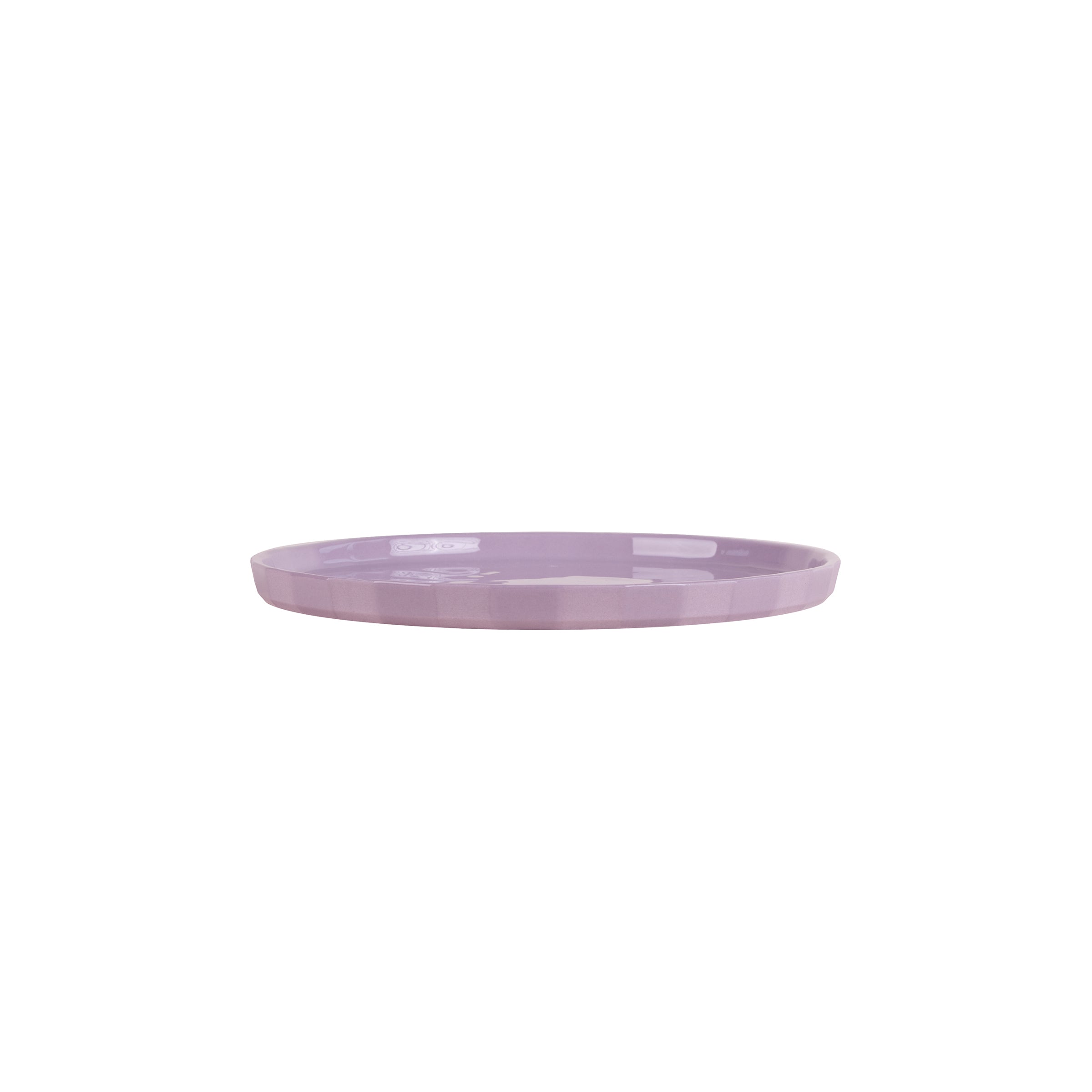 A round, flat lavender ceramic plate from Schneids Facet Tableware collection lies on a plain white background, showcasing its smooth surface and subtle glossy finish.
