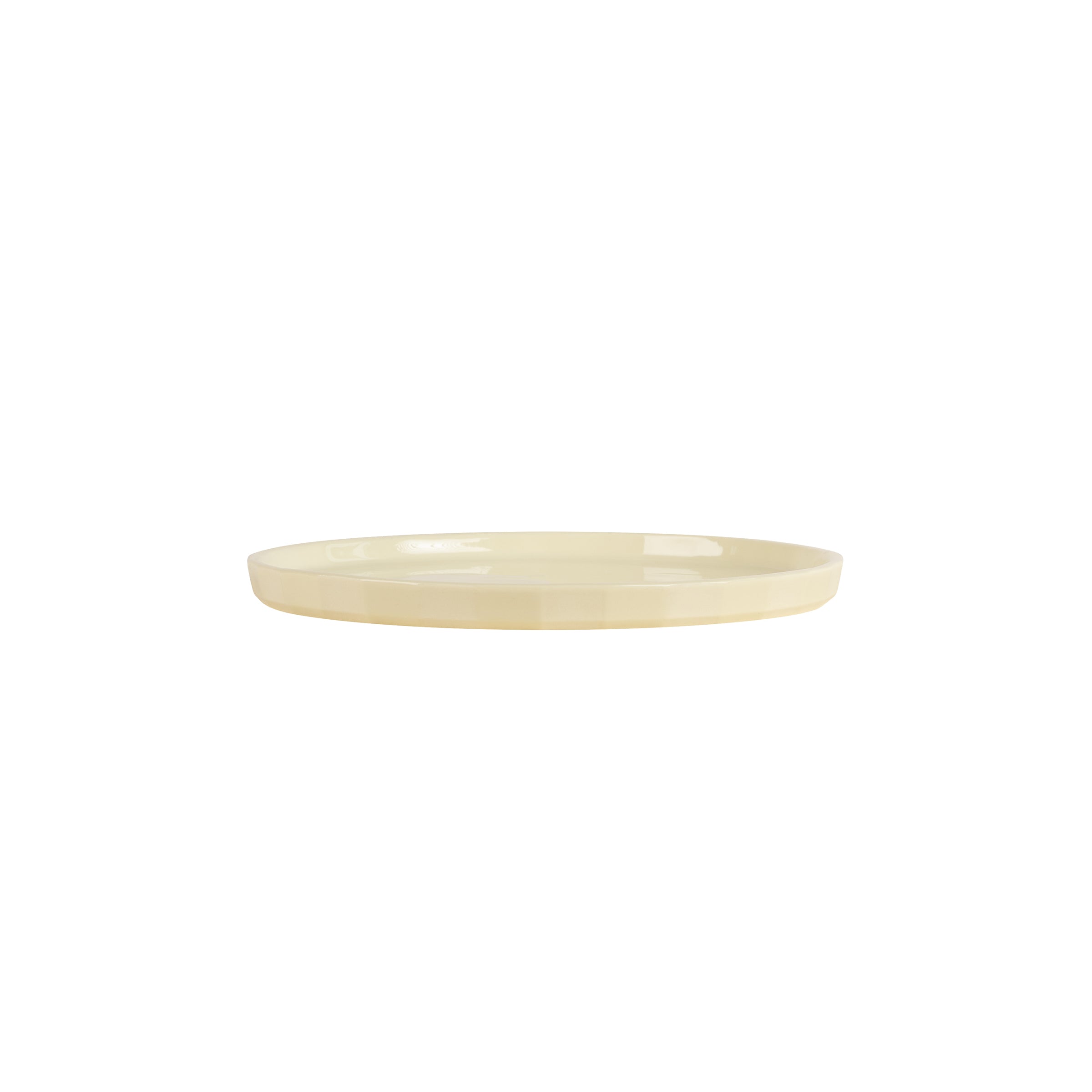 The Schneid Facet Tableware Plate is a simple, round, light beige ceramic plate with a smooth surface featuring a subtle striped pattern, positioned against a plain white background.