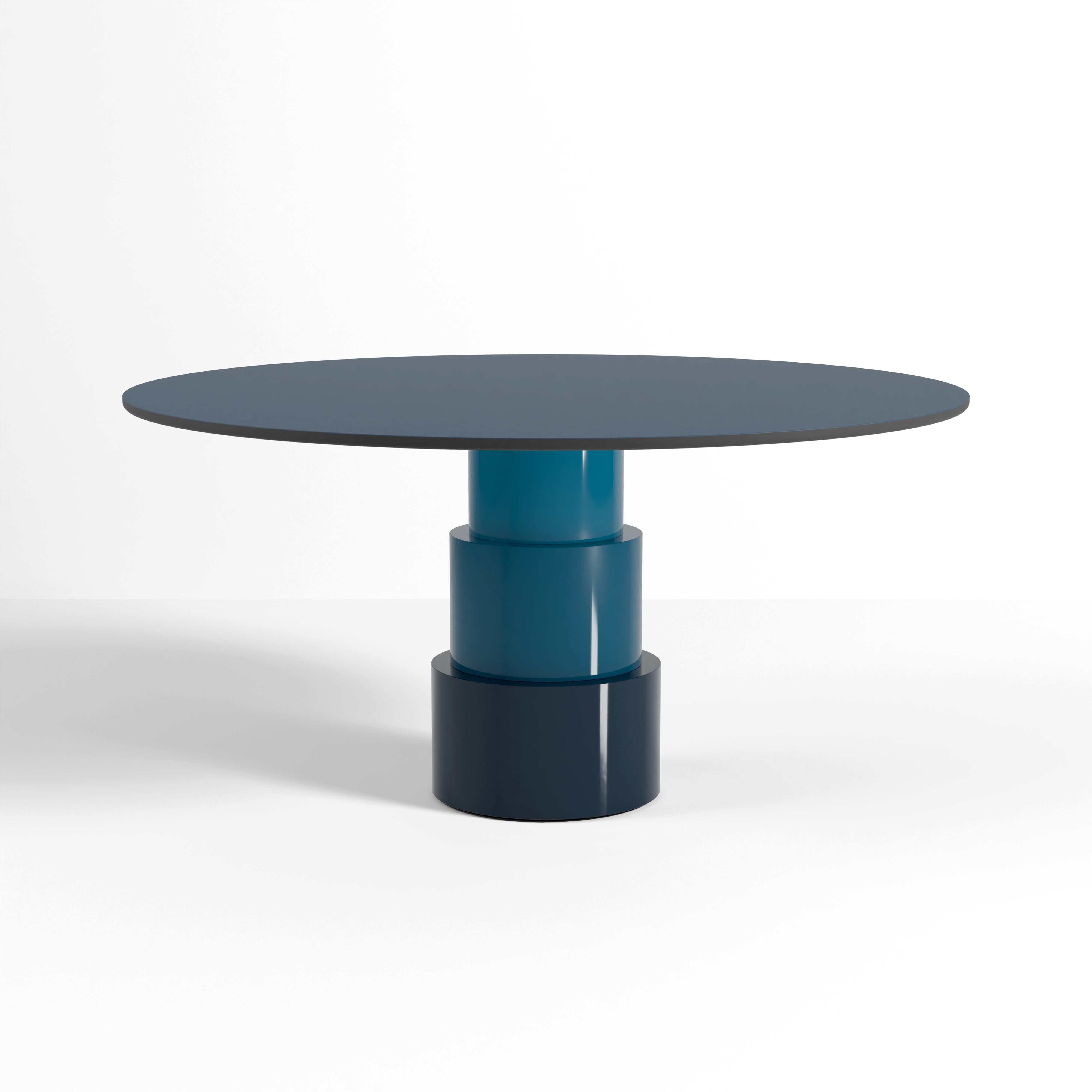 U Turn Table Linoleum with ocean blue powder-coated steel base and slim round linoleum tabletop design.