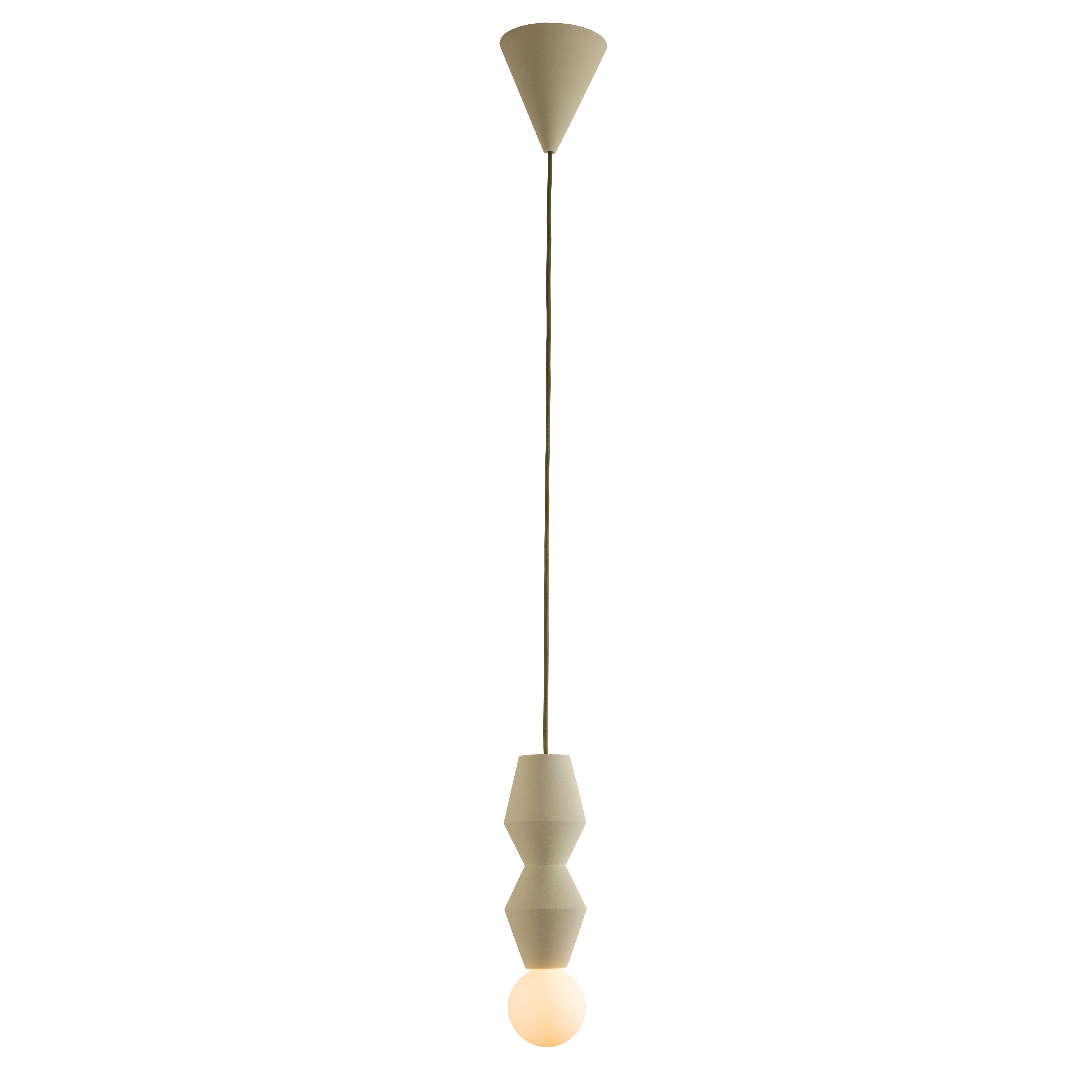 The Stucco No. II pendant light by Schneid has a minimalist design with a beige conical ceiling mount and cord, featuring ceramic geometric shapes stacked above a glowing bulb, elegantly contrasting simple lines with warm lighting.