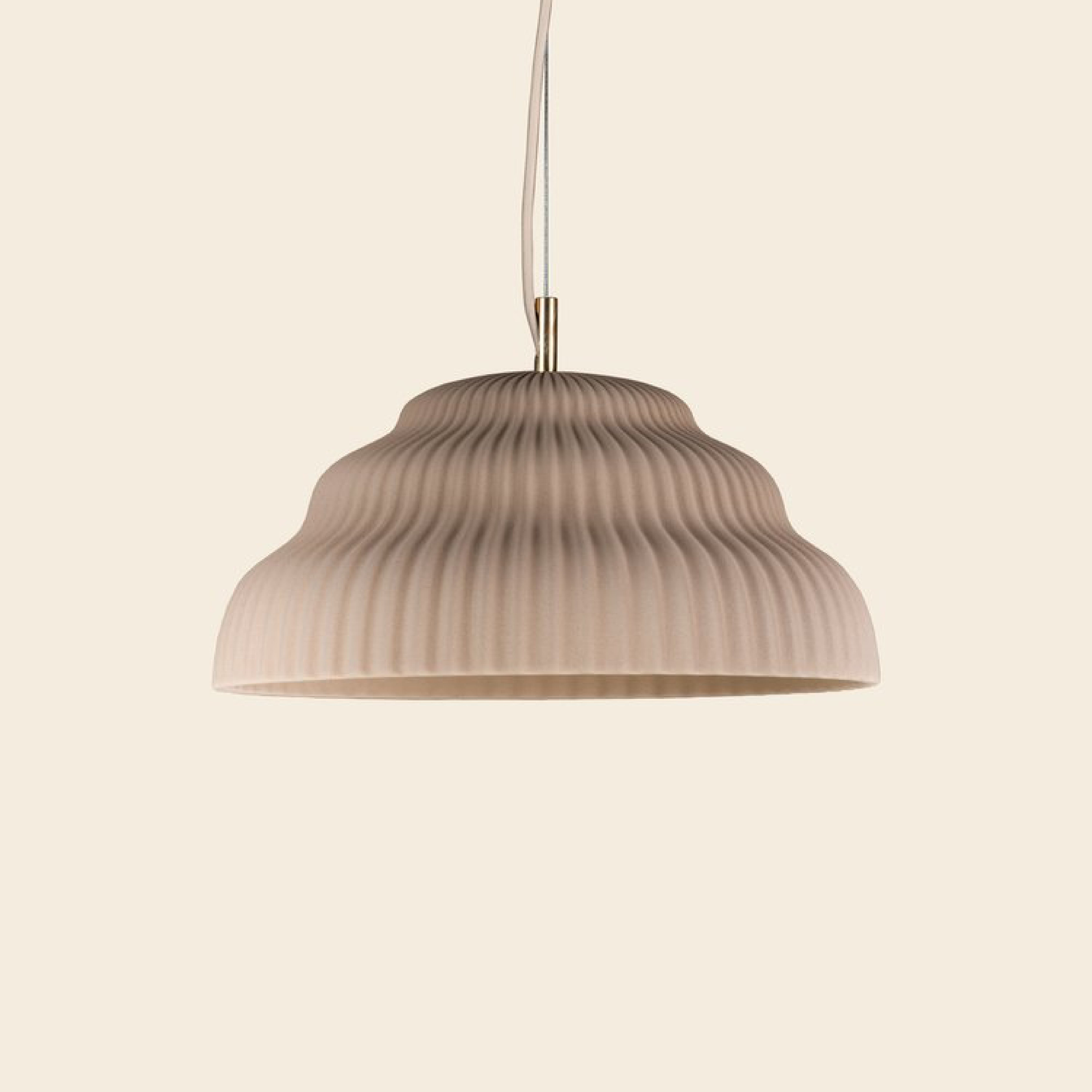 The Kaskad Biscotti by Schneid is a sleek ceramic suspension lamp with a cord that elegantly adds a modern touch to any space.