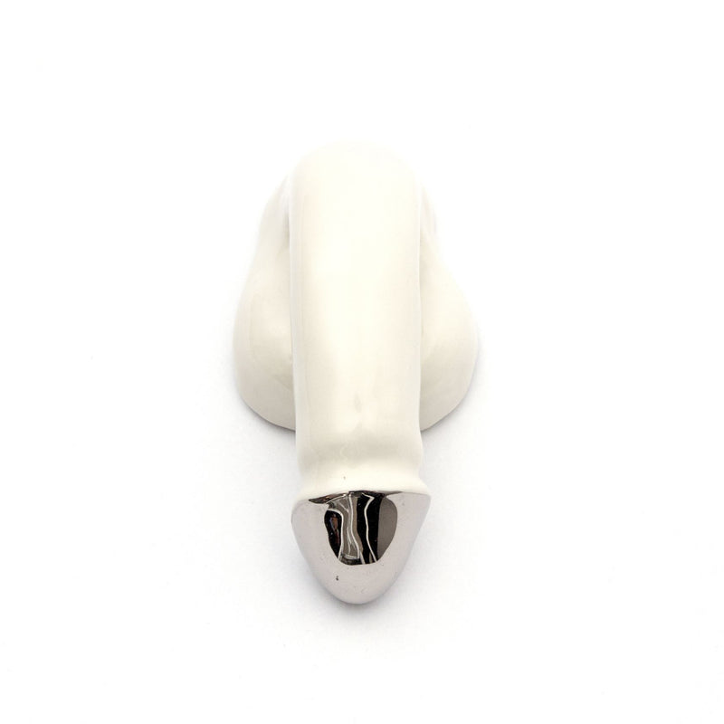 A handmade Austrian piece by Schwanzmanufaktur, the A Decorative Sex - Chrome sculpture is a white porcelain creation resembling an abstract elephant with a metallic silver tip and rounded base, adding artistic flair to any space.