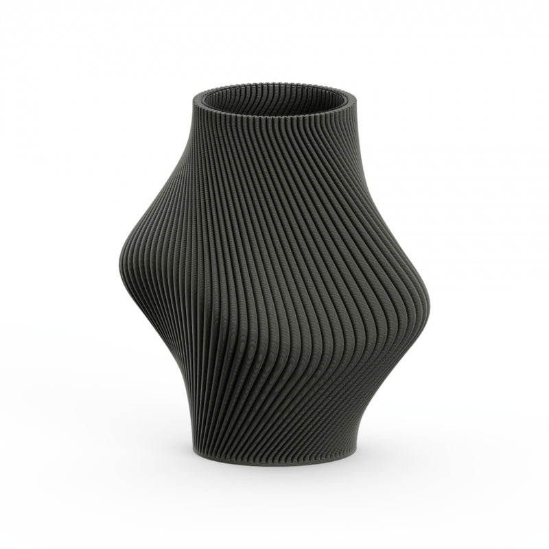 The Bloz 138g Vase by Sheyn features a black, intricately ribbed surface and wavy, curvy silhouette. Made with eco-friendly, recyclable materials, the 3D-printed design rests against a white background, showcasing its modern, artistic style and dynamic flow.