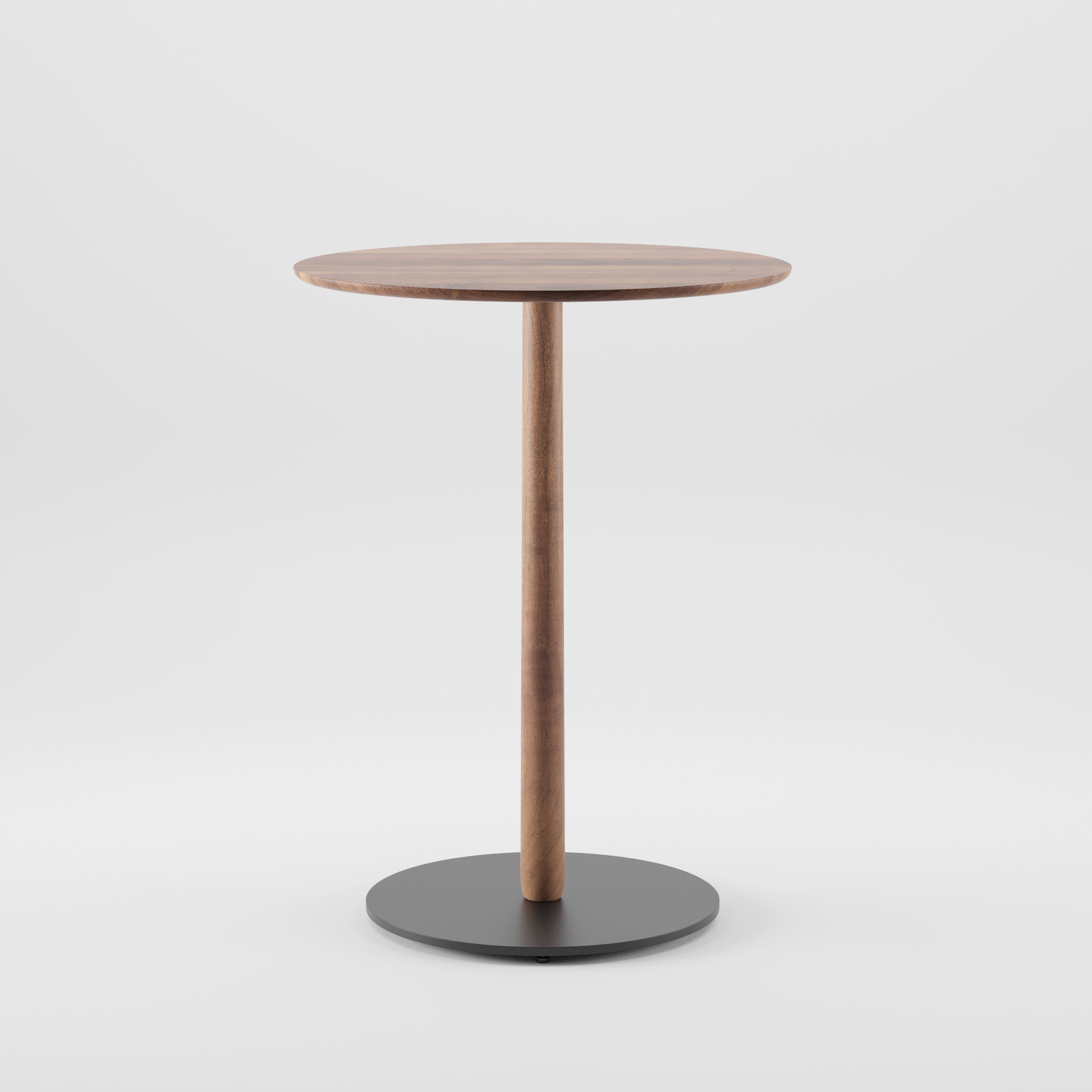 The Bistro B Table by Artisan is a round wooden table featuring a simple, modern design with a smooth circular top, single central wooden leg, and flat round black base. Made from environmentally-friendly solid wood against a plain white background.