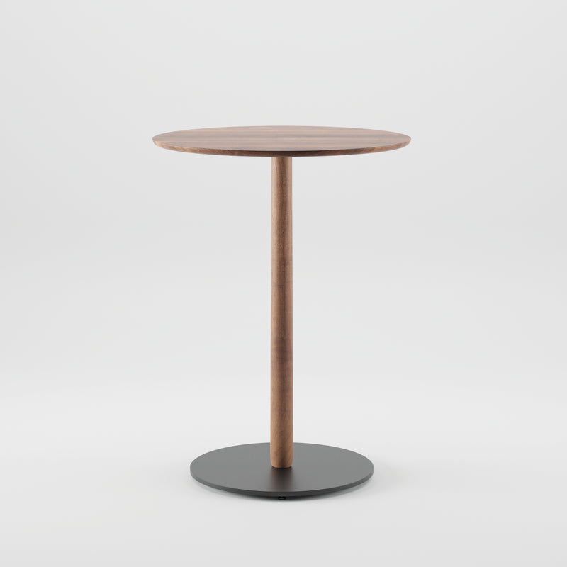 The Bistro B Table by Artisan is a round wooden table featuring a simple, modern design with a smooth circular top, single central wooden leg, and flat round black base. Made from environmentally-friendly solid wood against a plain white background.