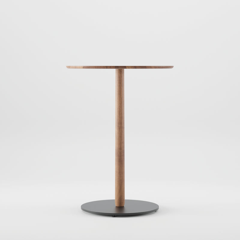 The Artisan Bistro B Table features a minimalist design with a smooth circular solid wood top and a central leg on a round black base, crafted from environmentally-friendly materials, offering simple elegance against a plain white background.