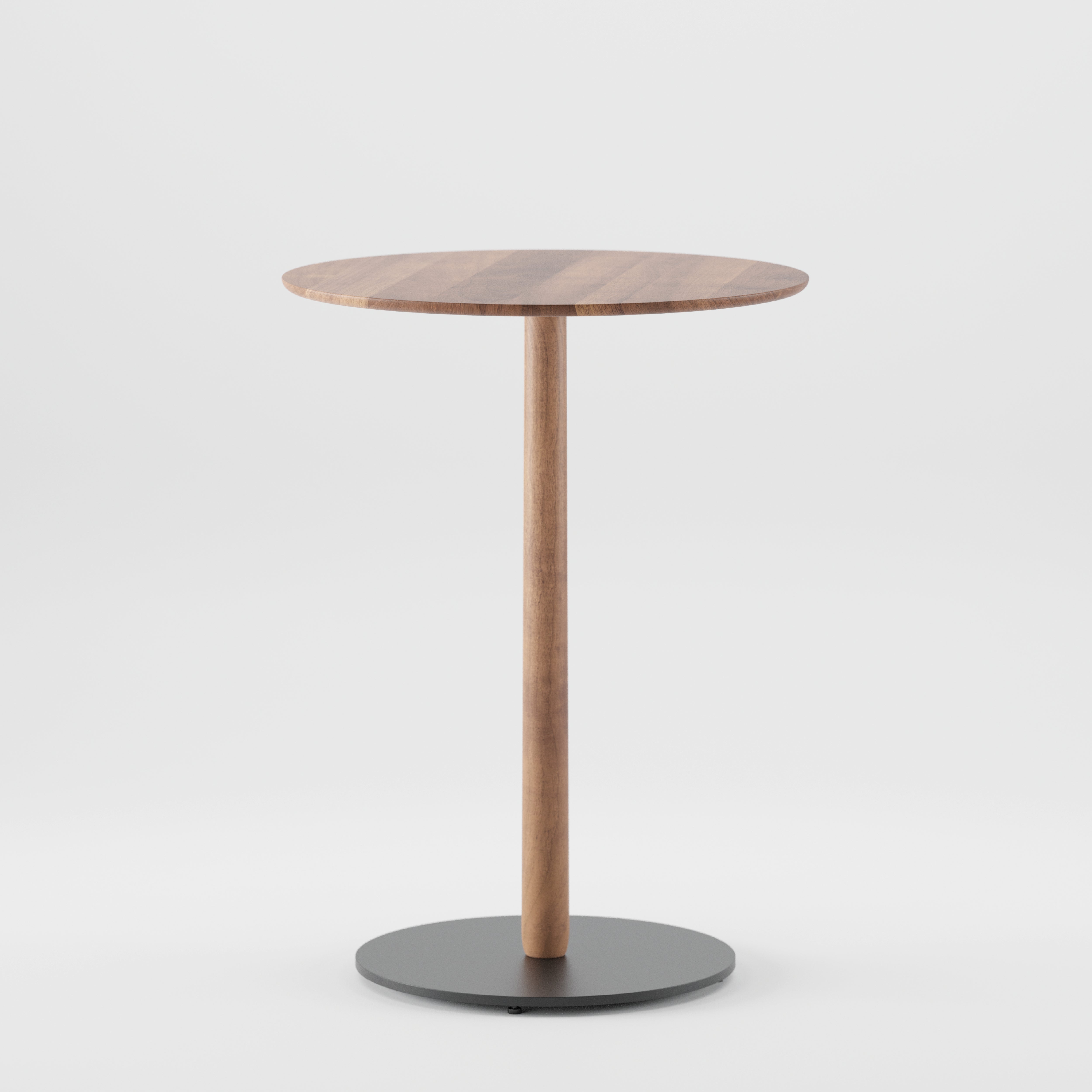 The Artisan Bistro B Table, a solid wood round side table, features a single central leg and circular black base. Its smooth tabletop showcases natural wood grain patterns enhanced by natural oils, all set against a plain white backdrop.