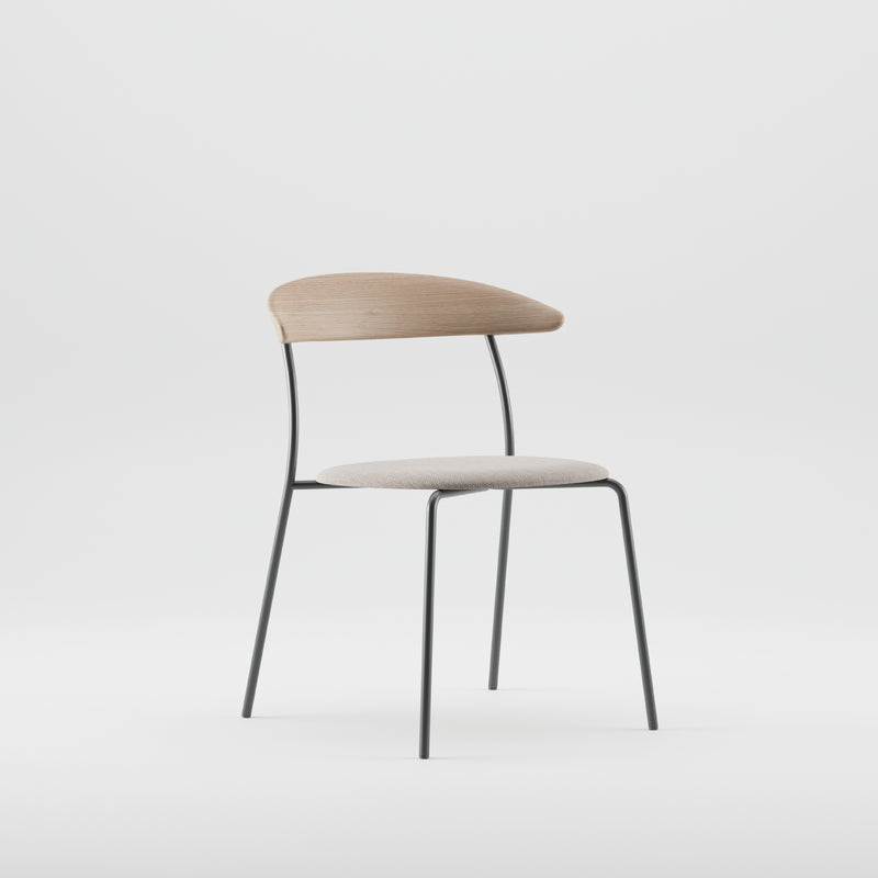 The Artisan KINU Chair boasts a minimalist design with a solid wood frame finished in natural oils. It features a curved wooden backrest, cushioned light gray fabric seat, slender black metal legs, and is set against a plain white background.