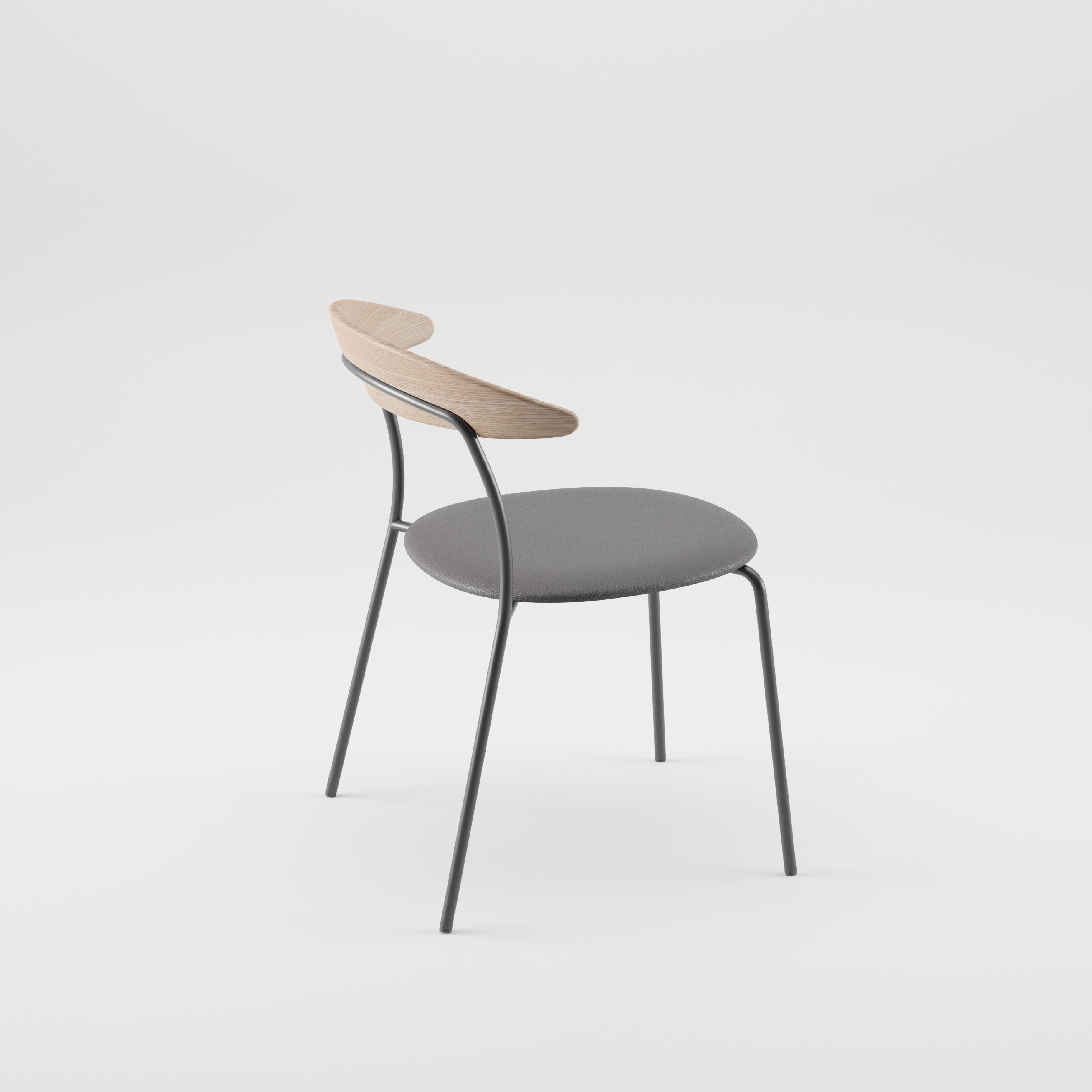 The KINU Chair by Artisan is a modern piece with a sleek design, featuring a gray cushioned seat, slender metal legs, and a curved solid wood backrest. Finished with natural oils, it emphasizes eco-friendly materials against a plain white background.