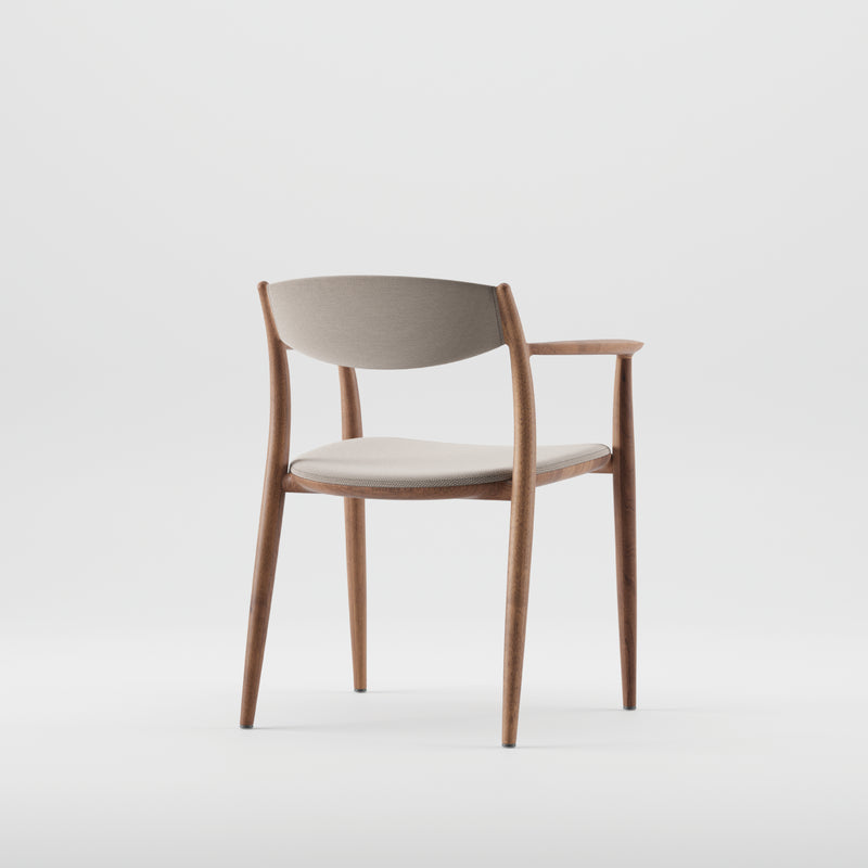 The NILA Chair by Artisan showcases a modern design with solid wood construction, featuring light gray cushioned seat and backrest. Its minimalist style is highlighted with sleek, rounded wooden legs and armrests, all presented from a back-side angle against a plain white background.