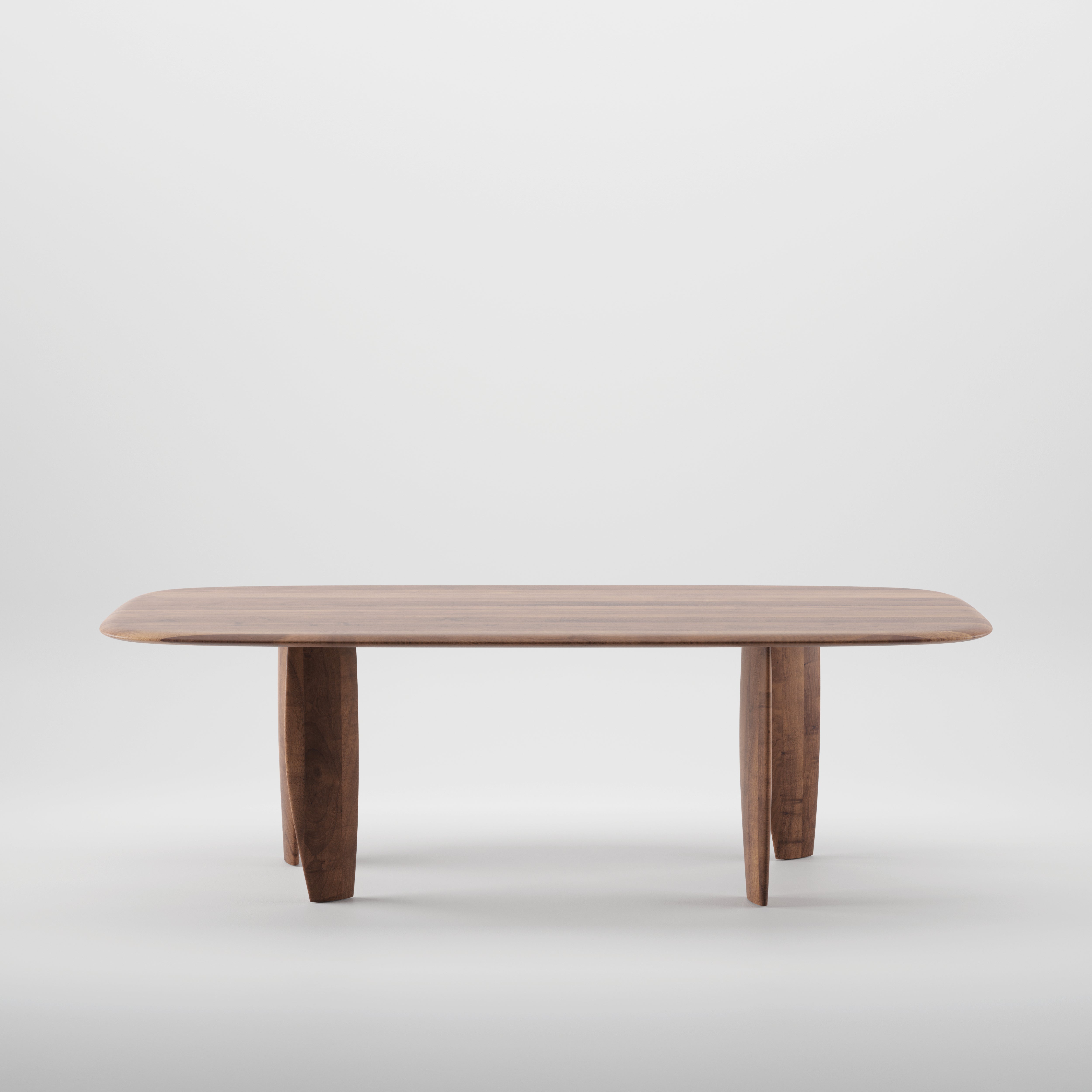 The NILU Table by Artisan features a solid wood construction with a smooth, rectangular top and rounded edges. Supported by four sturdy legs and treated with natural oils, it is displayed against a plain white background.