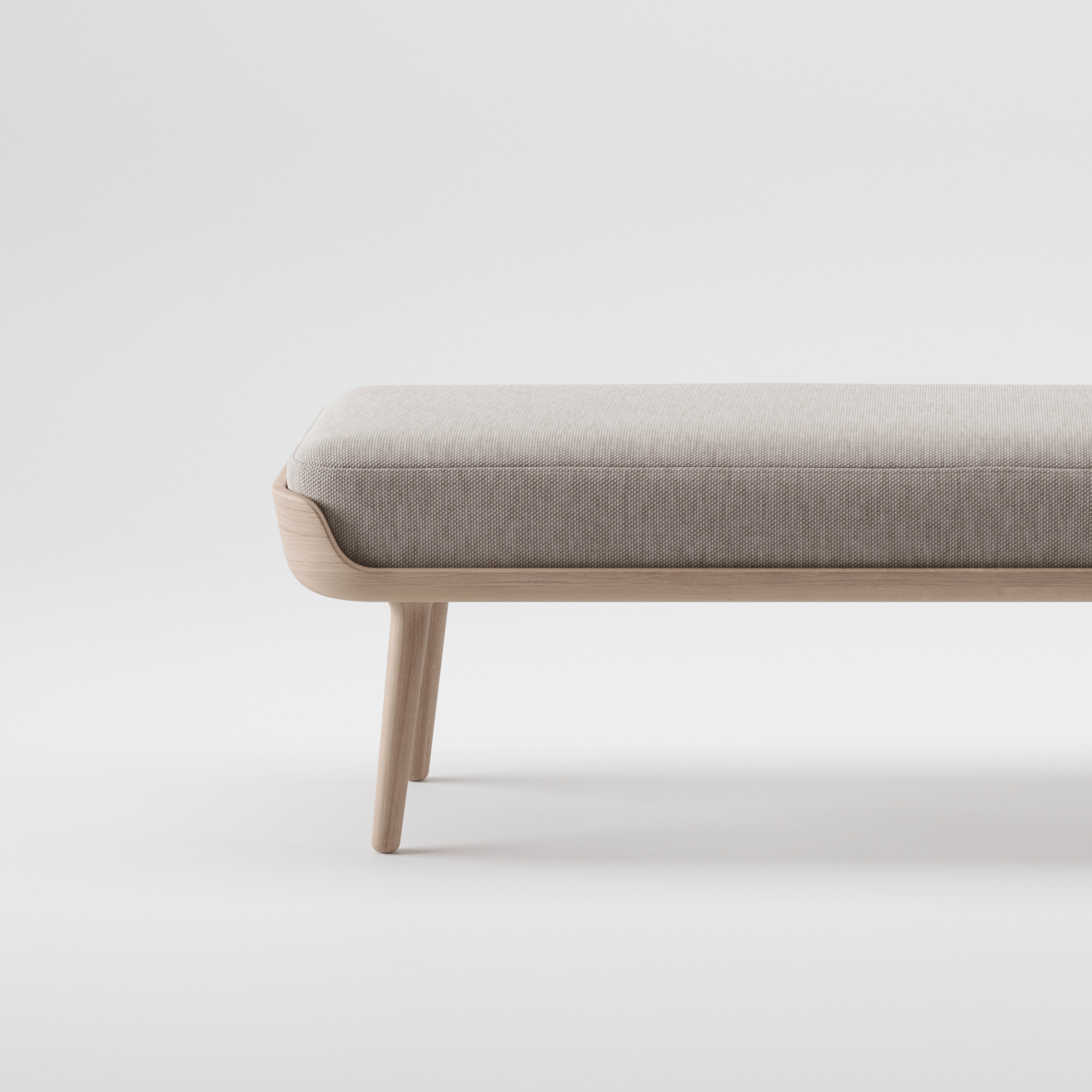 The THOR Bench by Artisan is a minimalist, modern piece with a light gray cushion and an eco-friendly, solid wood frame. Its sleek design highlights the natural wood texture against a plain white background, supported by four sturdy legs.