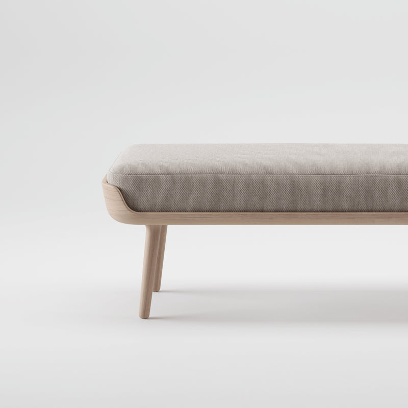 The THOR Bench by Artisan is a minimalist, modern piece with a light gray cushion and an eco-friendly, solid wood frame. Its sleek design highlights the natural wood texture against a plain white background, supported by four sturdy legs.
