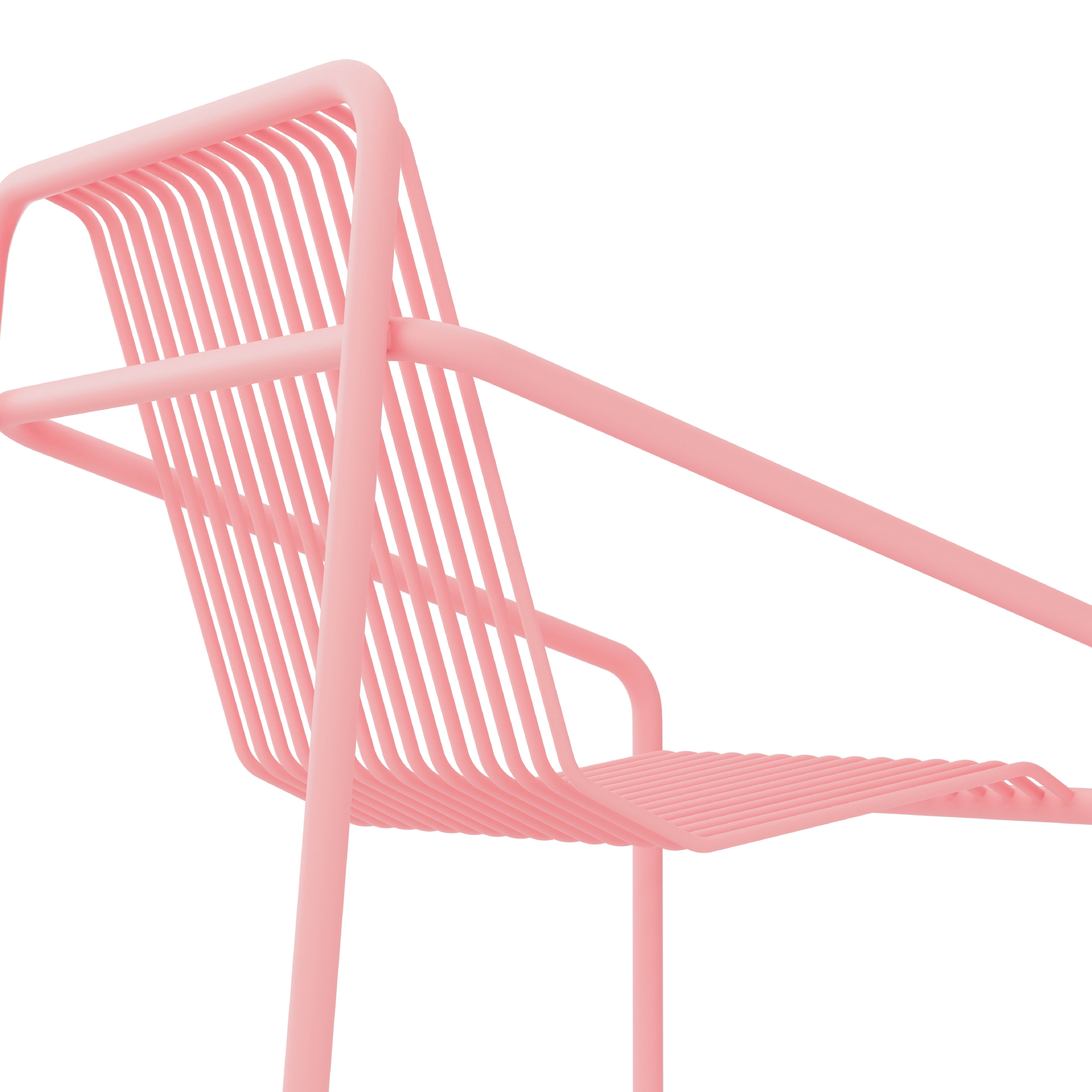 Zoom in on the modern pink metal IVY Outdoor Dining Chair by Objekte unserer Tage. Its sleek, slatted design is weather-resistant, with lines accentuated against a white background that highlight its contemporary style.