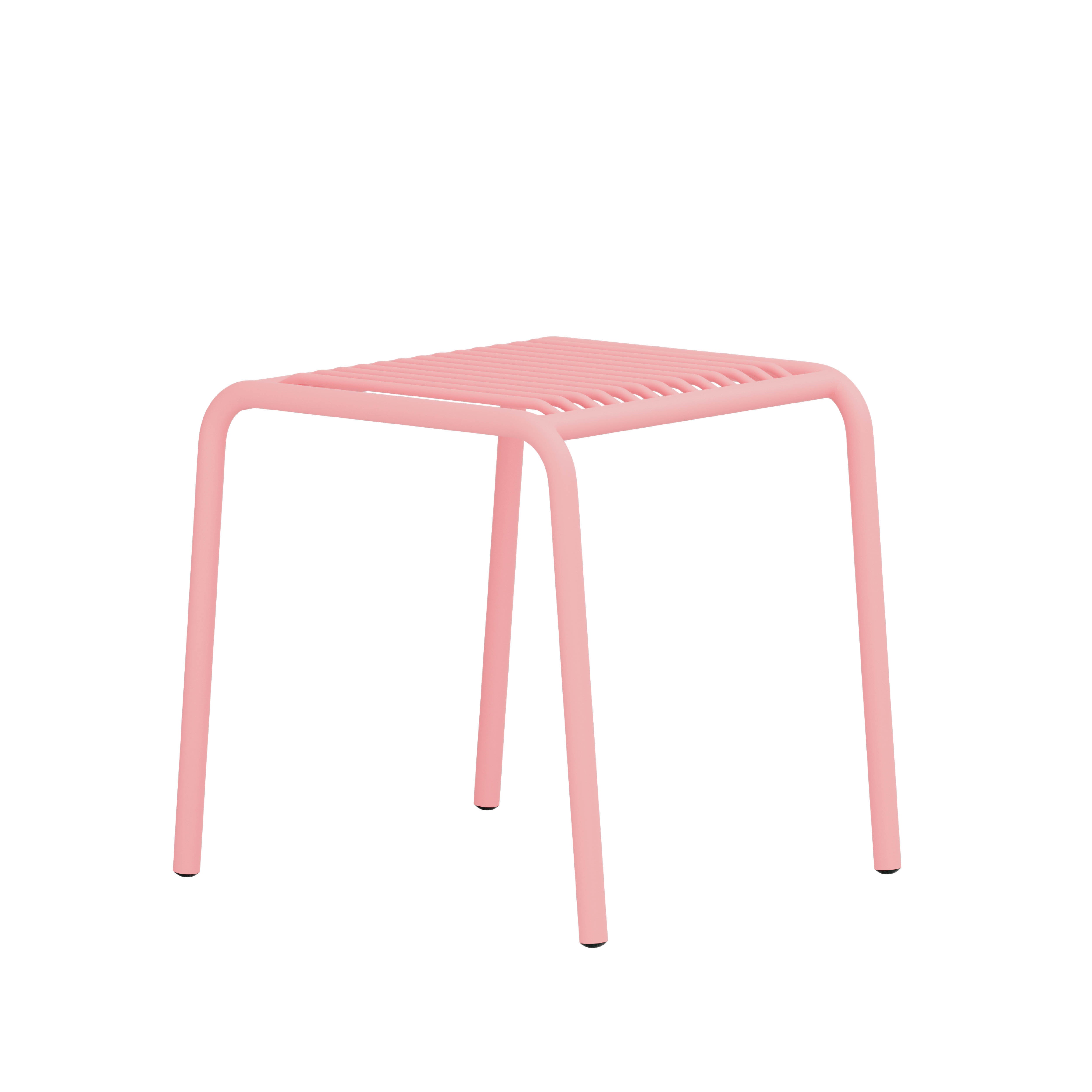 The IVY Outdoor Stool by Objekte unserer Tage is a minimalist pink metal stool with a ribbed seat and four curved legs, made from powder-coated steel. Its sleek design is perfect for modern outdoor spaces, shown against a white background.