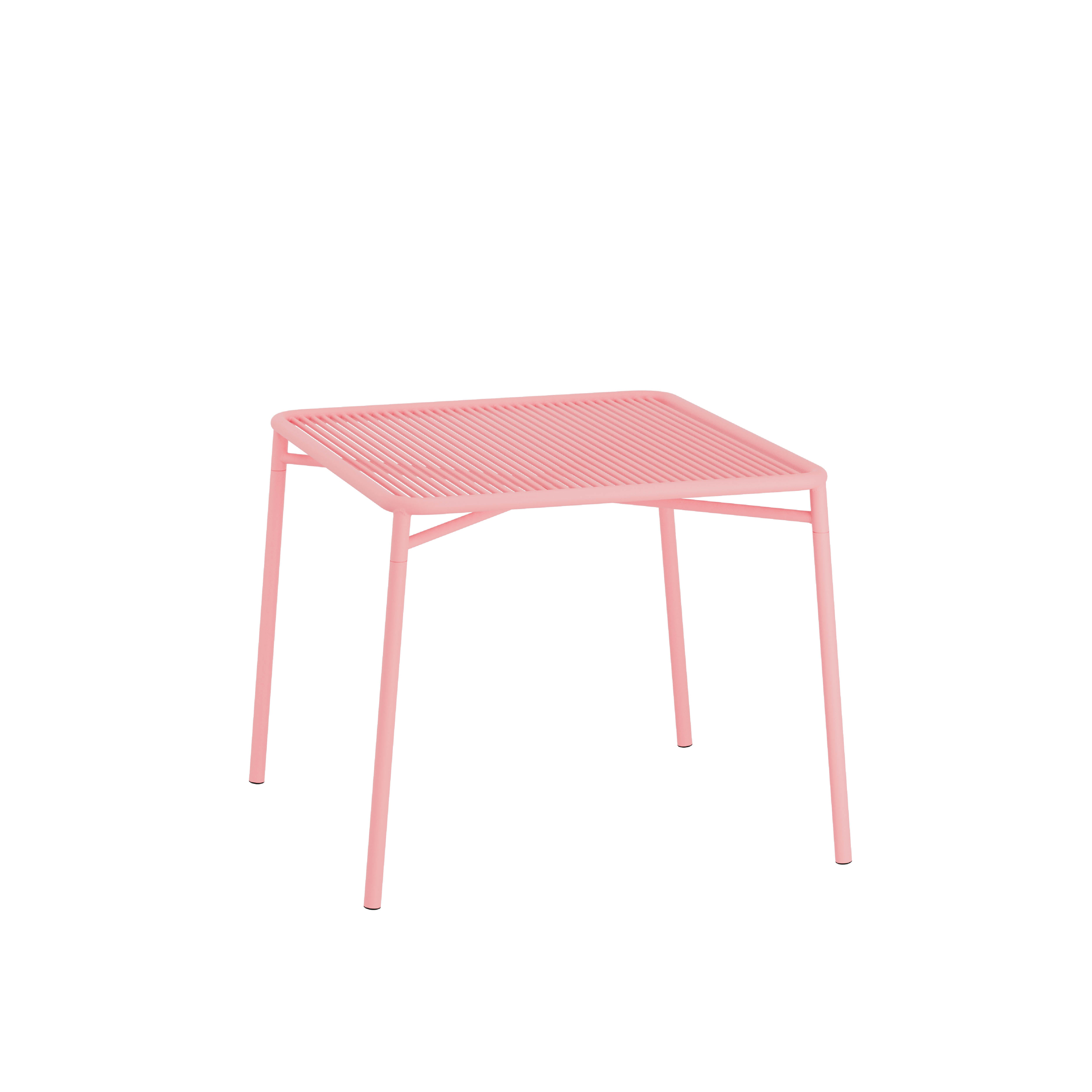 The IVY Outdoor Table by Objekte unserer Tage is a minimalist pink metal design crafted from powder-coated steel, with a slatted top and four slim legs. This elegant piece from our outdoor collection is shown against a white background.