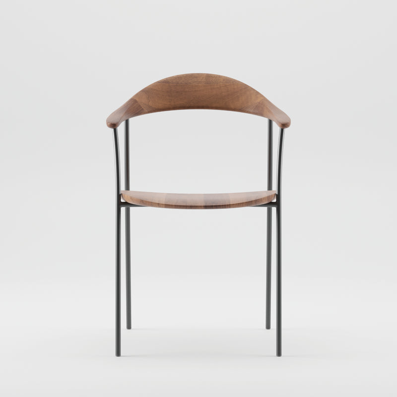 The NEVA contour chair by Artisan showcases a curved wooden backrest and seat, complemented by sleek black metal legs, set against a plain white background.