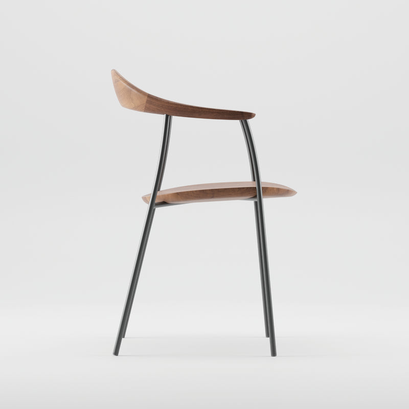 Side view of the NEVA contour chair by Artisan, highlighting its sleek, minimalist design with a wooden seat and backrest on a slender black metal frame against a plain white background.