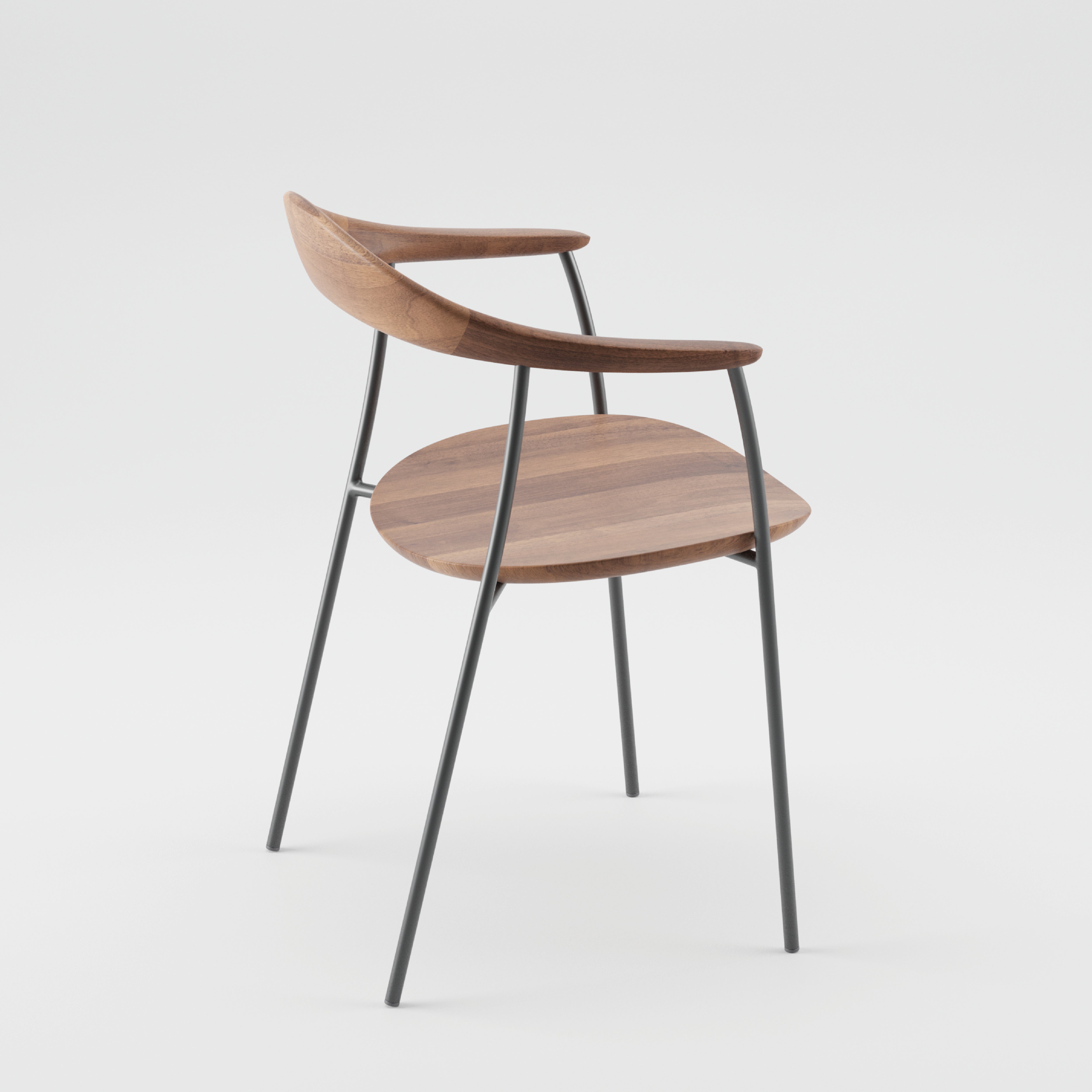 The NEVA contour chair by Artisan features a modern wooden seat and backrest with a curved design and thin black metal legs for a minimalist look. Photographed on white, it highlights the seamless blend of CNC carving and traditional handcraft.