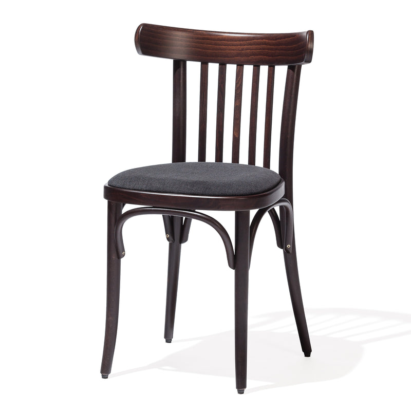 The TON Chair 763 - Upholstered, with its beech dark wooden frame and curved backrest featuring vertical slats, offers a cushioned seat in dark fabric. It has slightly angled legs with support braces, ideal for modern interiors.
