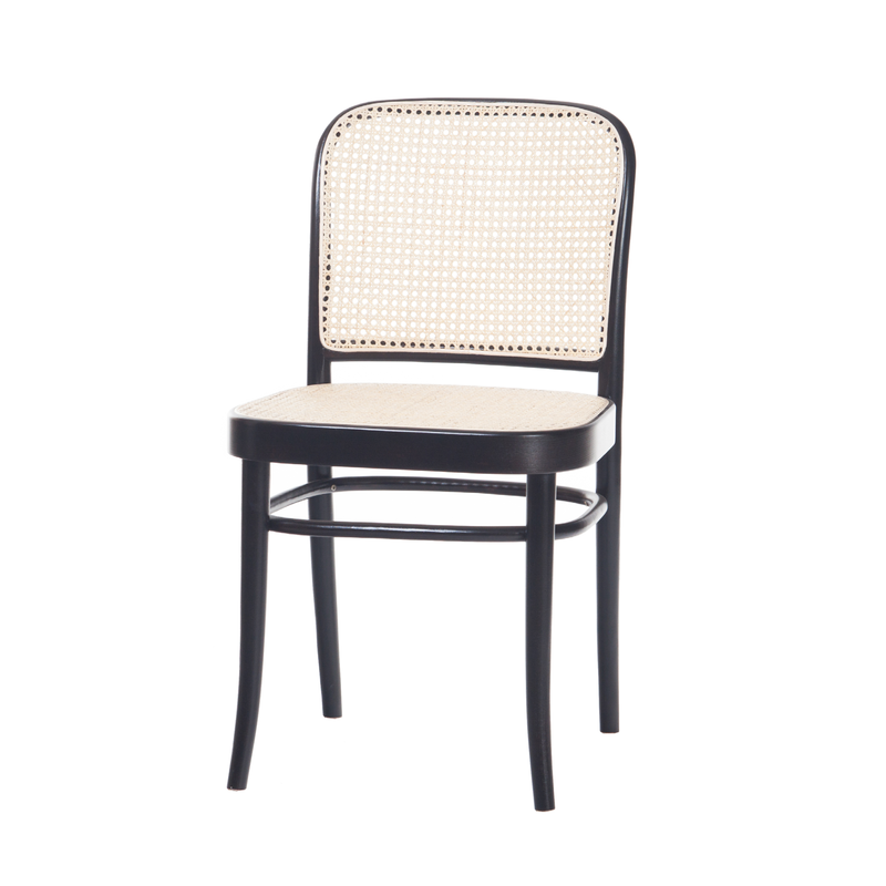 The Chair 811 - Cane by TON features a black wooden frame with a curved backrest and cane wicker detailing on the back and seat, set against a white background, embodying the elegant artistry of Art Nouveau style.