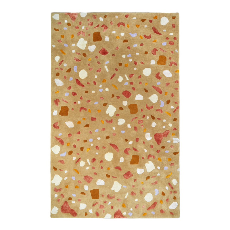 Rectangular light brown rug with irregular abstract shapes in white, rust, orange, and lavender scattered across surface