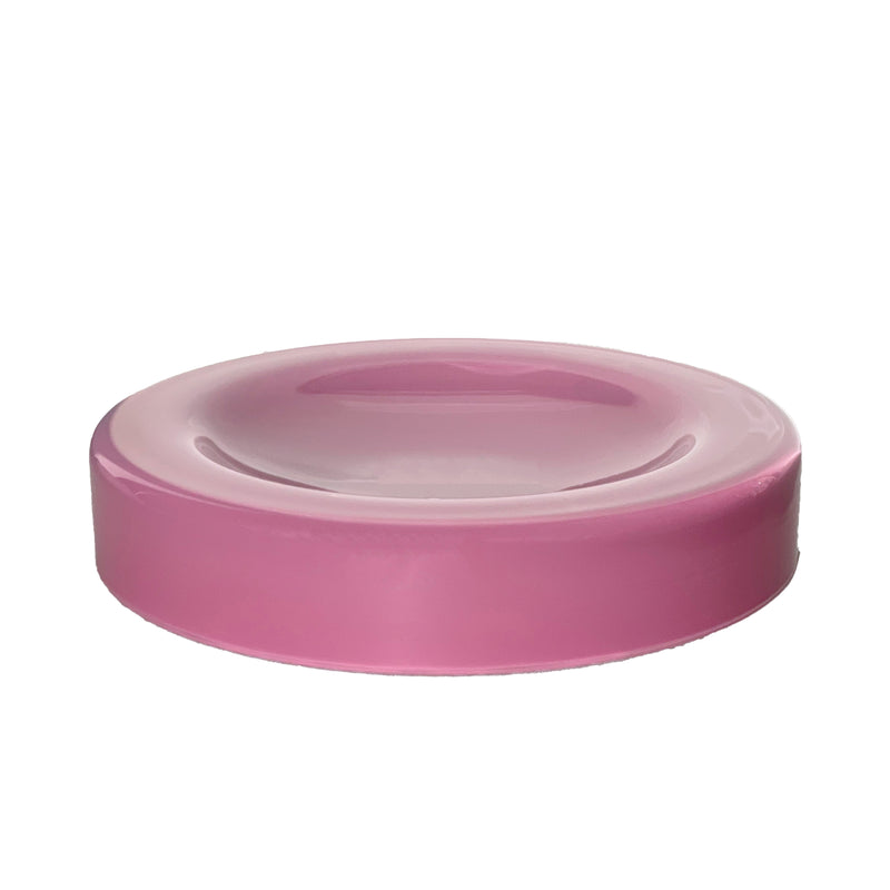 A round, pink ceramic WET Bowl Big by Ursula Futura with a slightly raised edge is centered against a white backdrop. Its glossy finish adds surface tension, giving it an elegant touch like mouth-blown glass.