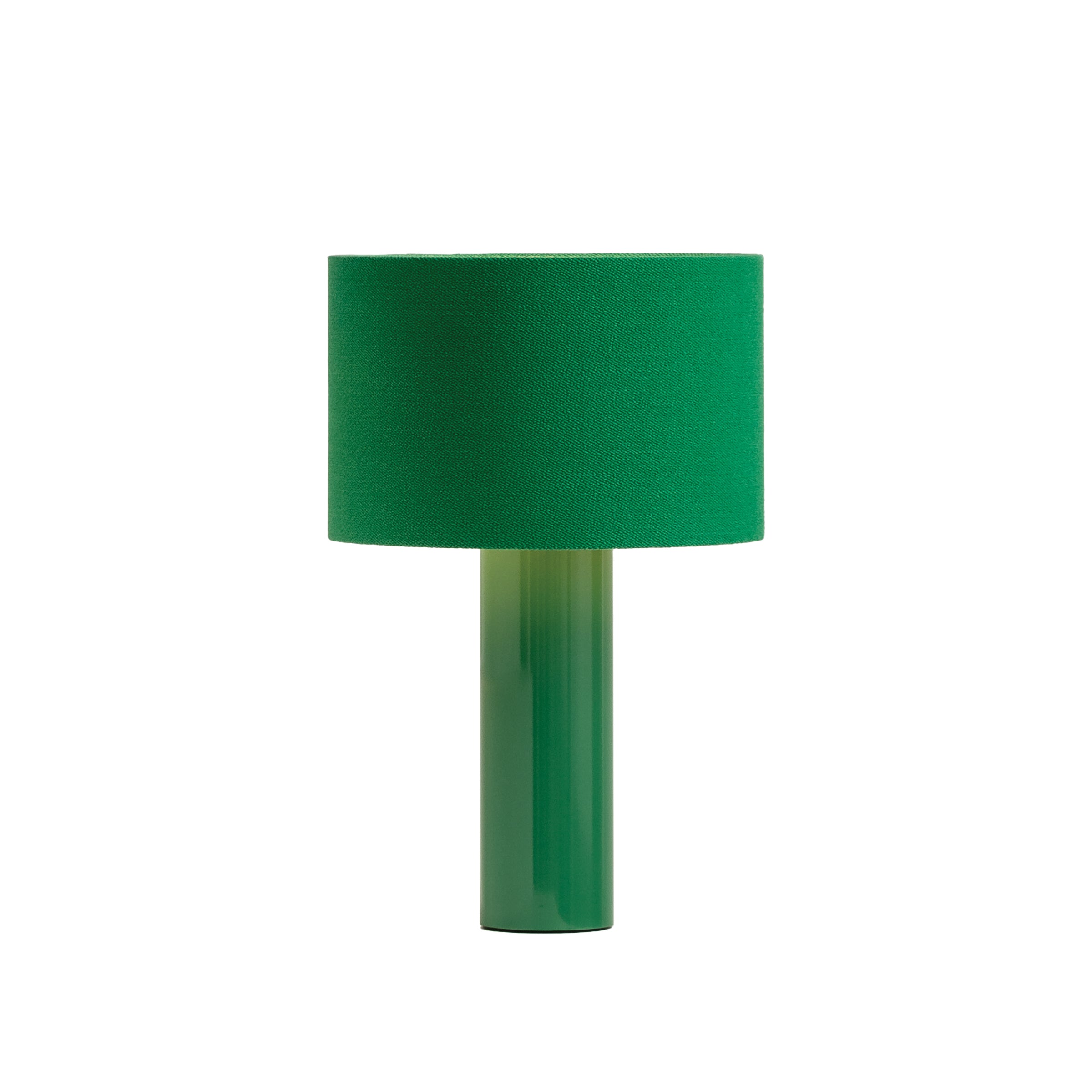 The ALL ROUND Table Lamp by Victor Foxtrot showcases a modern design with a cylindrical green glass base, powder-coated steel accent, and a matching green fabric drum shade against a plain white background.