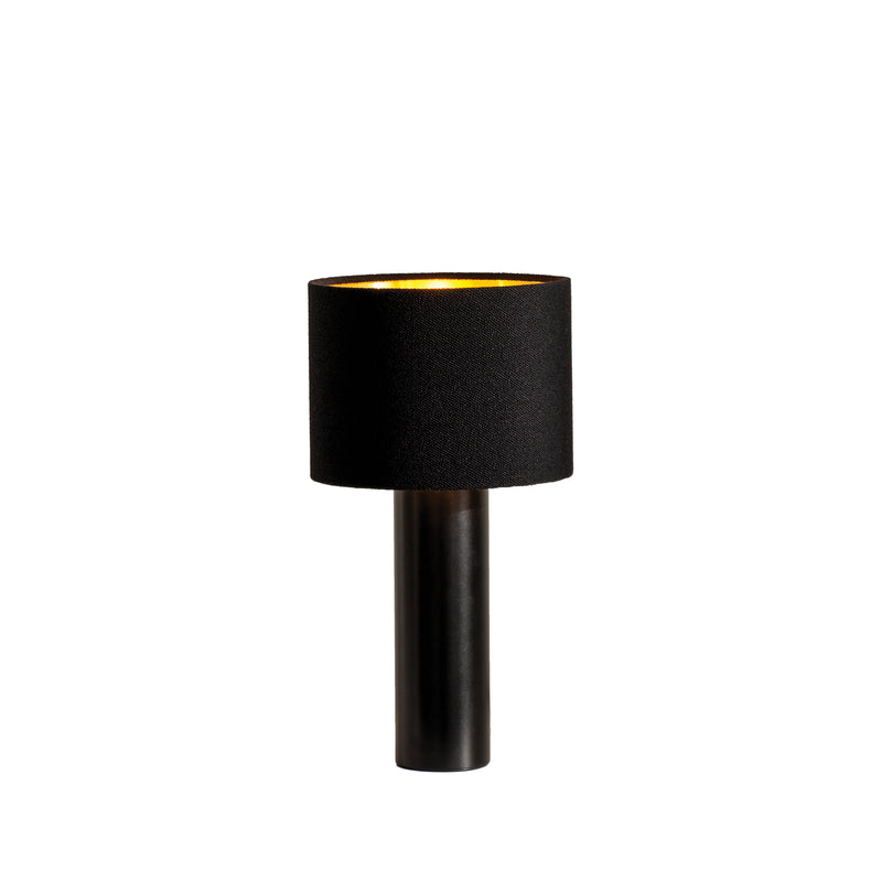 The ALL ROUND MINI Table Lamp by Victor Foxtrot features a modern black look with a gold-toned wool fabric lampshade and a cylindrical base, standing elegantly against a plain white background to exude contemporary charm.
