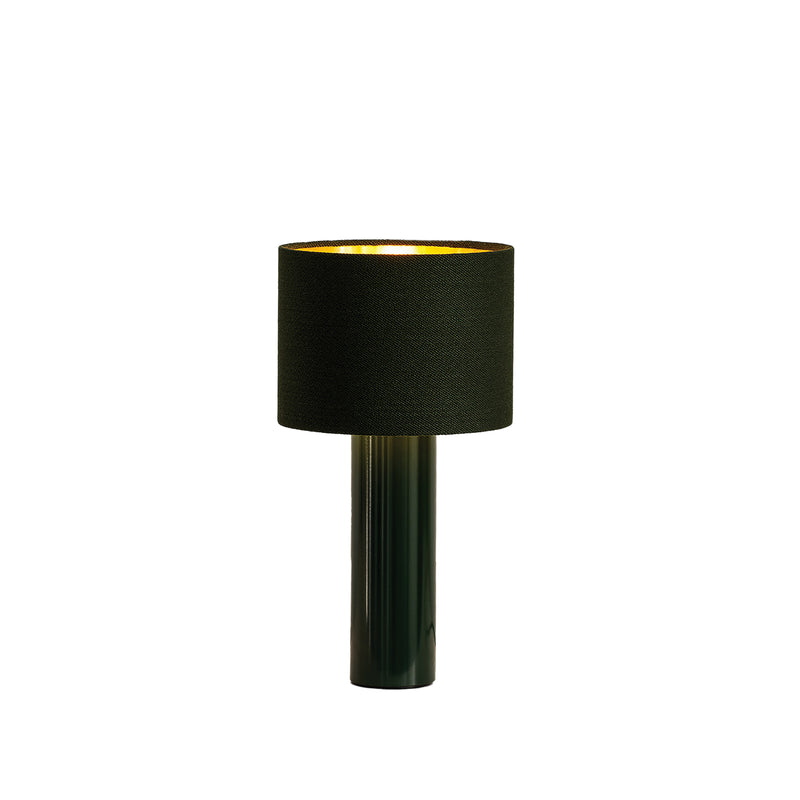 The ALL ROUND MINI Table Lamp by Victor Foxtrot boasts a black cylindrical base with a wool fabric drum shade, casting a warm glow. Its modern design complements any decor, set against a pure white background.