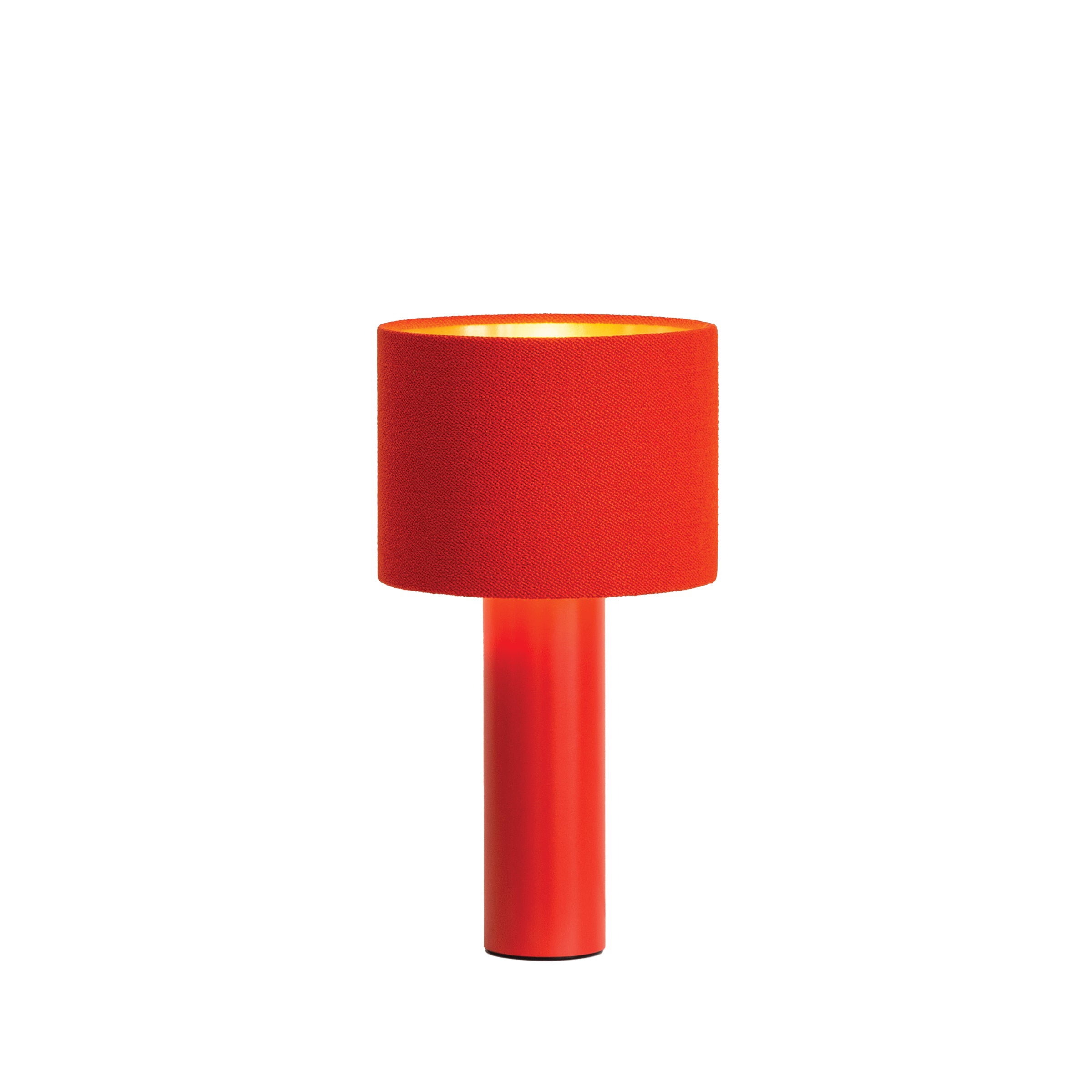 The ALL ROUND MINI Table Lamp by Victor Foxtrot boasts a sleek modern design with a red cylindrical base and matching wool fabric lampshade. Emitting a warm glow, it adds a contemporary touch to any space.