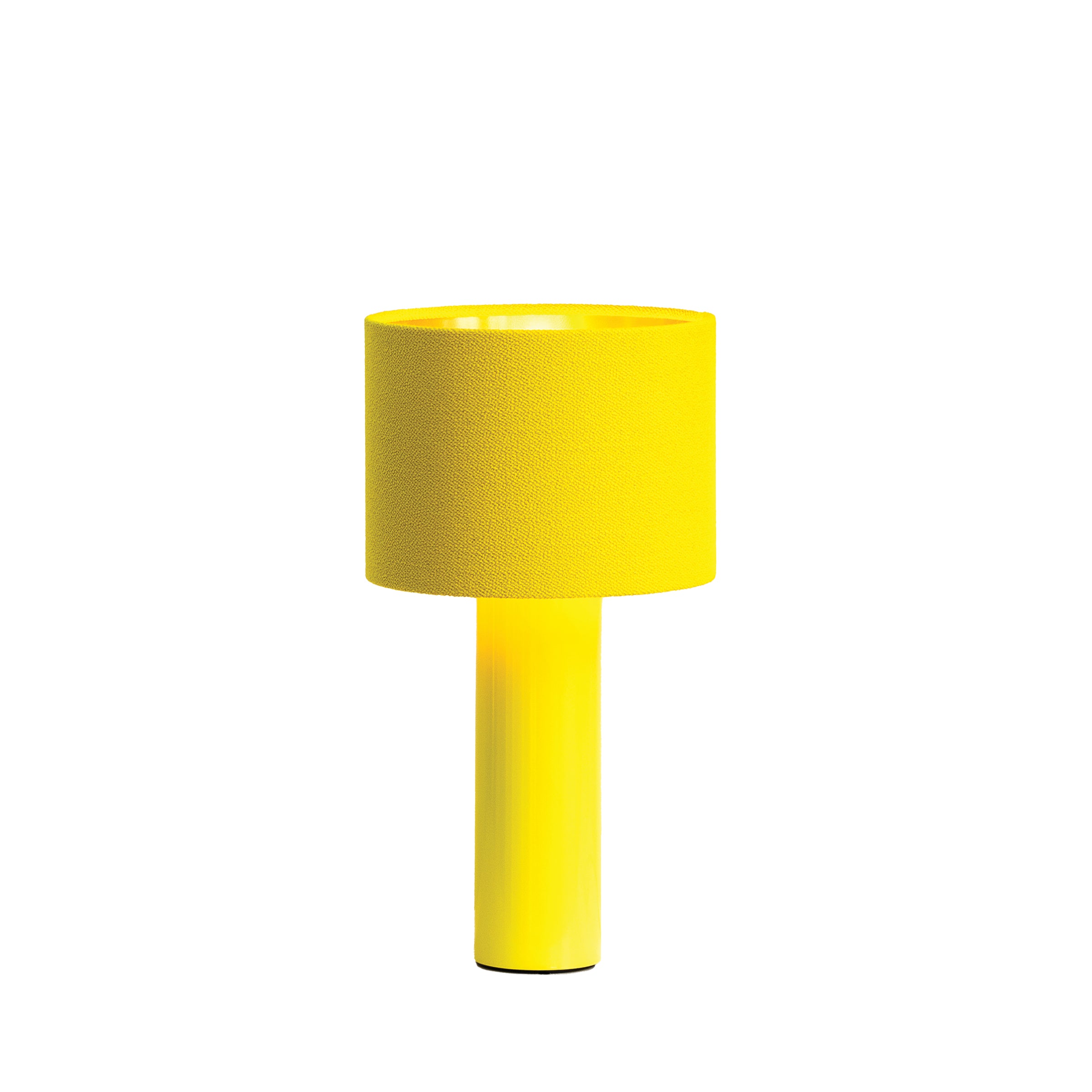 The vibrant yellow ALL ROUND MINI Table Lamp by Victor Foxtrot features a cylindrical base and a wool fabric drum shade. Its set against a crisp white background.