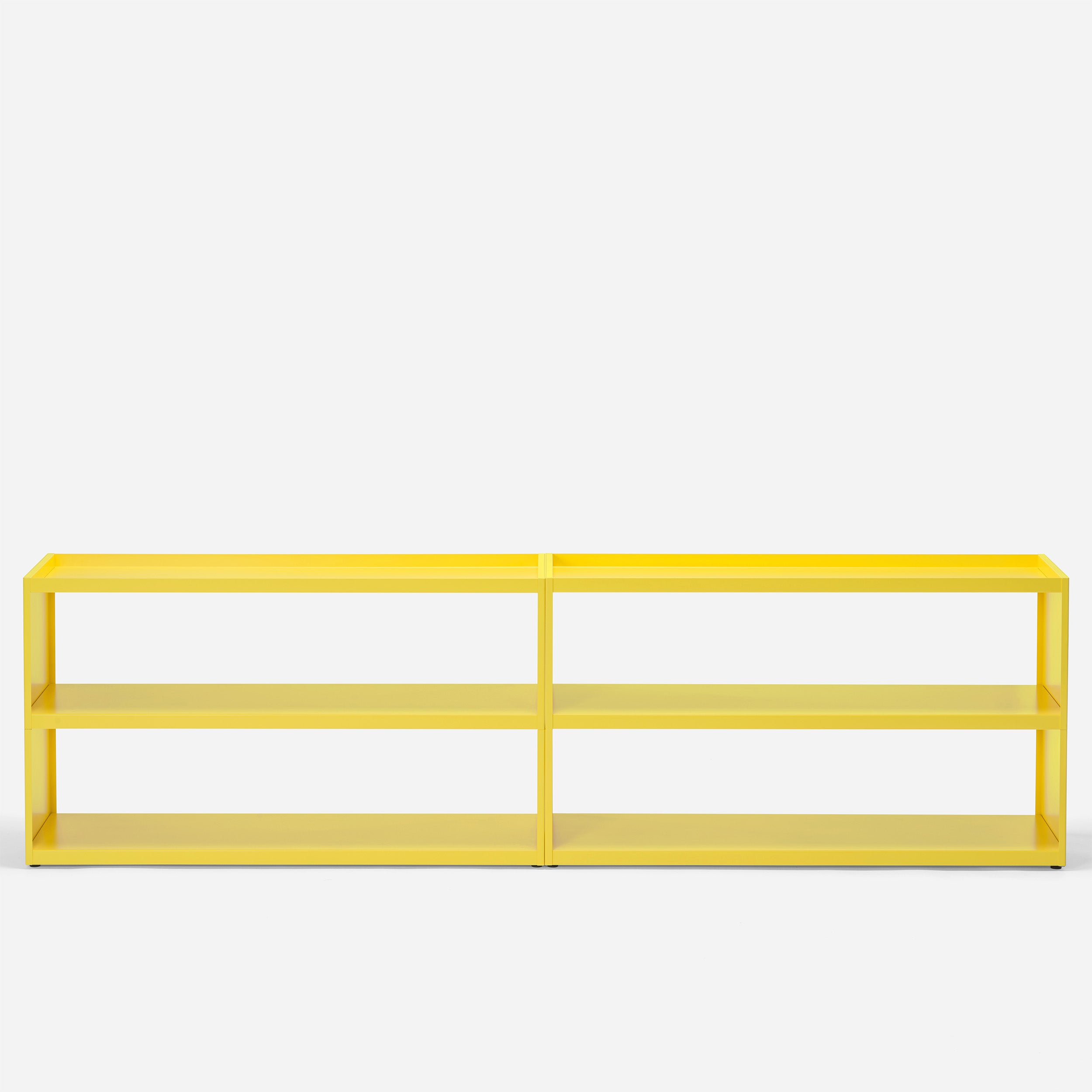 The W1 Stack Shelves by Loehr is a modern, bright yellow shelf with a minimalist design, featuring two spacious rectangular sections and four tiers. Its sleek structure stands out against a plain white backdrop, highlighting its vibrant color.