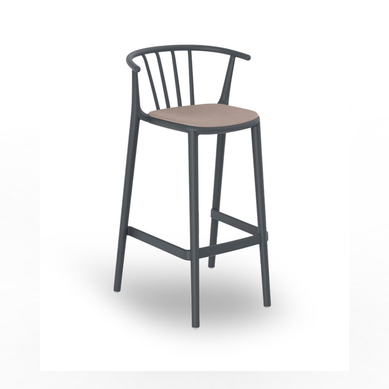 The Resol Woody Stool Upholstered is a modern bar stool featuring a dark frame, light brown cushioned seat, curved backrest with vertical slats, and footrest. Sustainably crafted for versatile use indoors and outdoors, it stands elegantly on four legs against a white background.