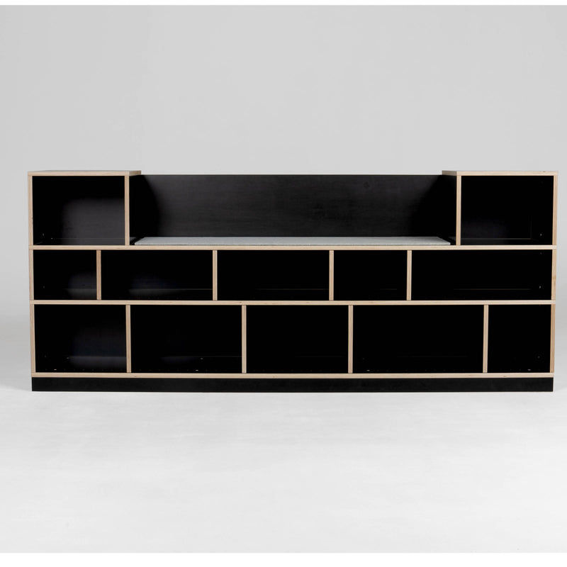 The Egal Sitzboard by Moormann is a modern black bookshelf with a geometric design, featuring customizable open rectangular shelves of varying sizes arranged symmetrically. Light-colored edges contrast the black surfaces, offering style and functionality similar to a refined sideboard.