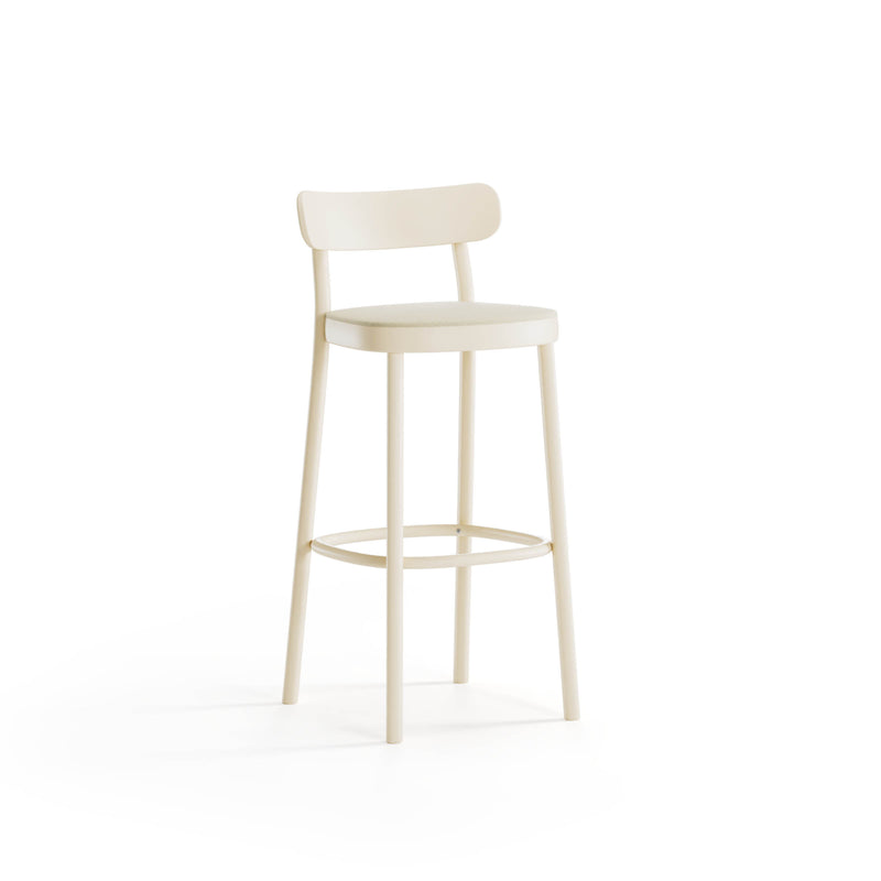 The Barstool La Zitta by TON, designed by Alexandr Gufler, showcases a minimalist cream style with a round seat and curved backrest. Its four slender legs and circular footrest provide modern elegance against a plain white backdrop.