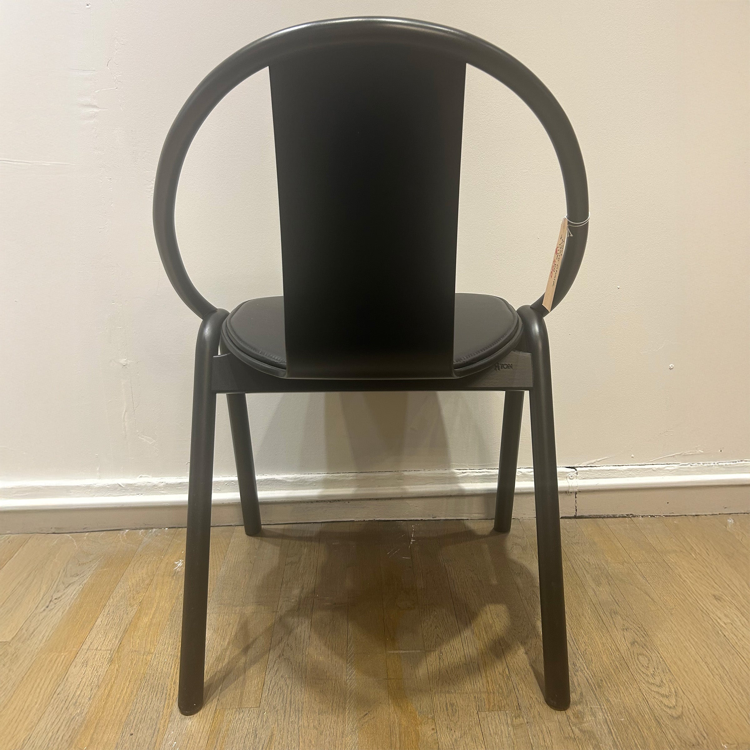 Chair Again - Sale: black bentwood stackable chair with curved backrest and plywood seat on wooden floor.