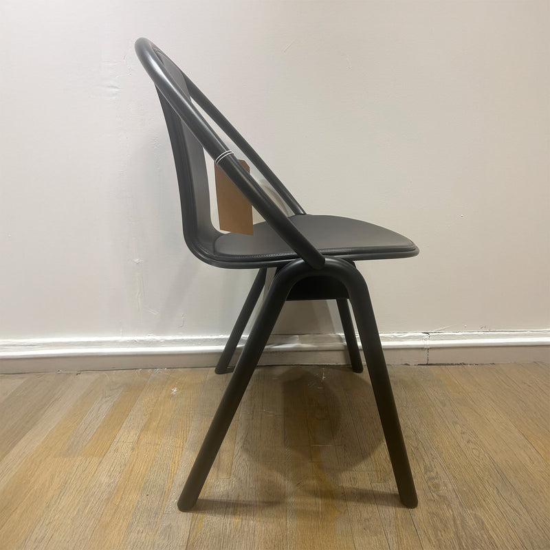 Chair Again - Sale: black bentwood chair with plywood seat and curved beech wood frame, stackable design against white wall.