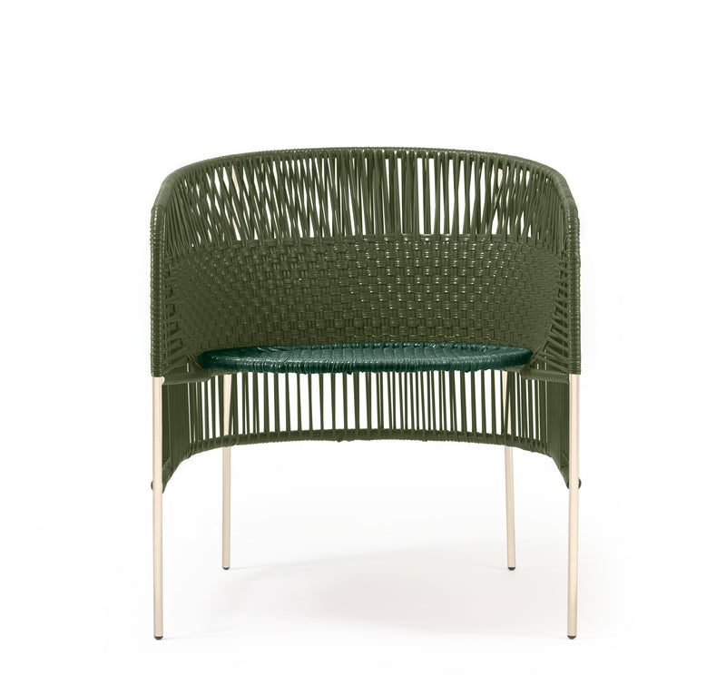 The Ames Caribe Chic Lounge Chair by Ames features a green woven design with a rounded backrest and seat on four slim, light-colored legs. Inspired by Colombian weaving crafts, it reflects Sebastian Herkner’s distinctive Caribe Chic series style. Plain white background.
