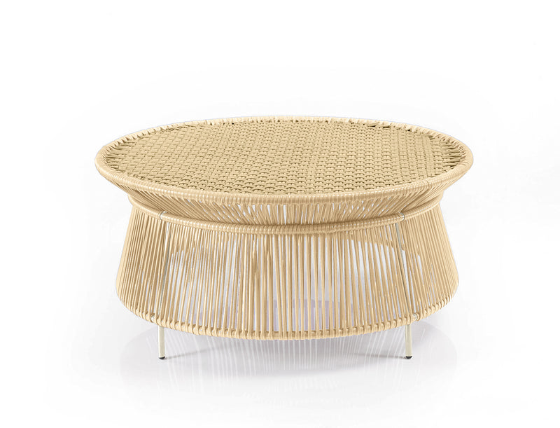 The Ames Caribe Chic Low Table by Ames is a round, woven rattan coffee table with a wide, flat top and open base, showcased against a plain white background.