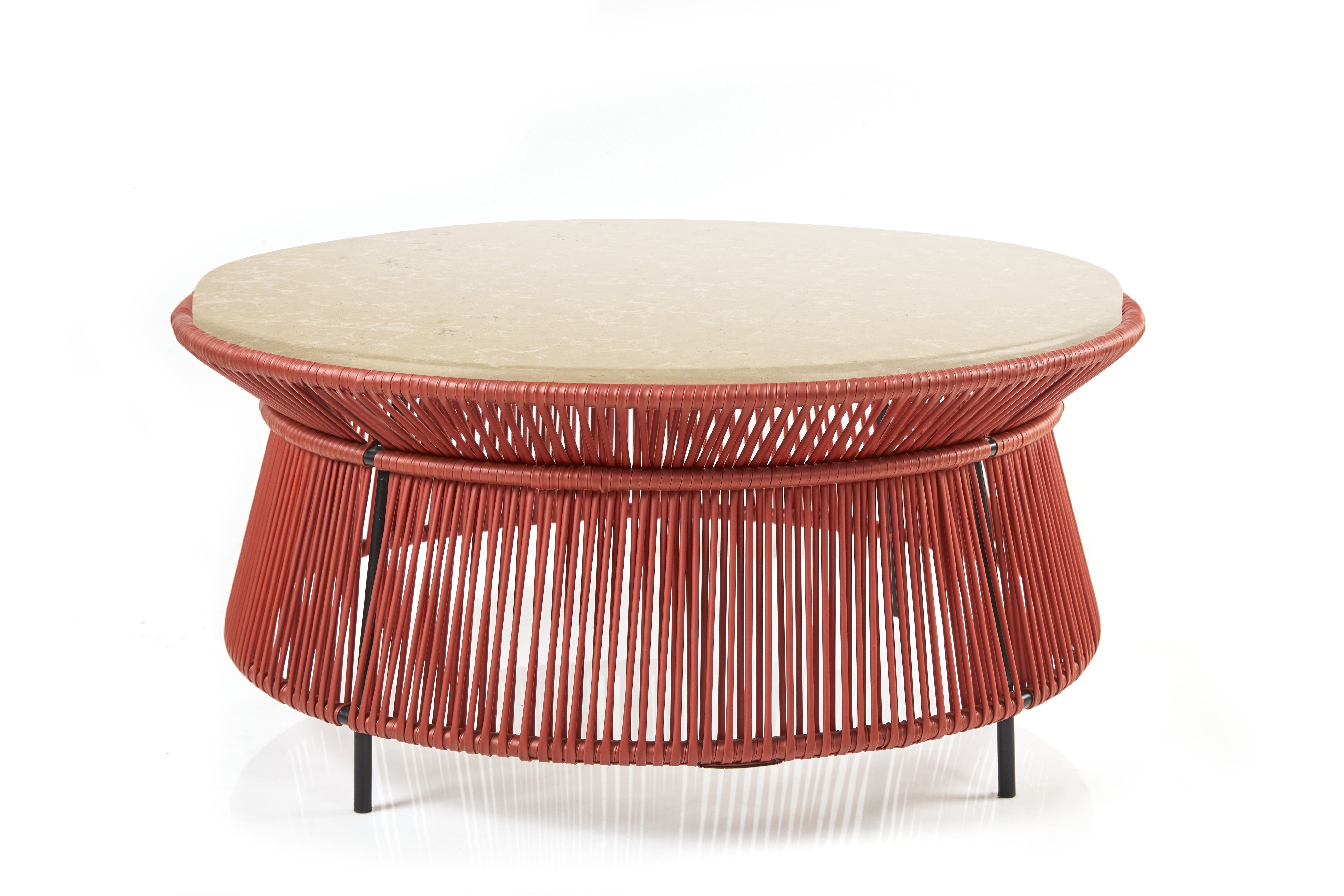 The Ames Caribe Chic Low Table by Ames, designed by Sebastian Herkner, features a beige marble top, red woven cord base, and slim black metal legs, shown against a white background.