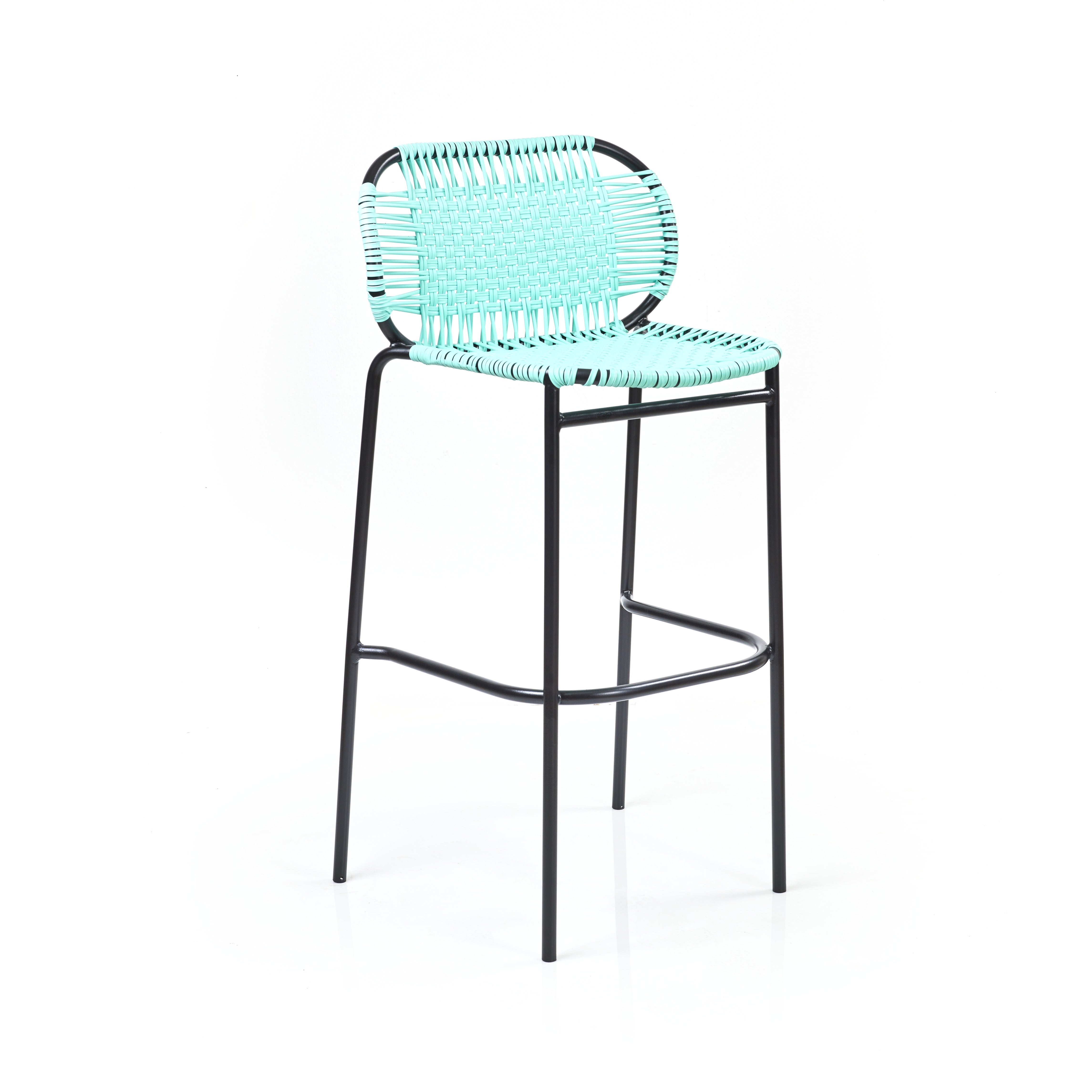 The Ames Cielo Barstool by Ames features a tall black metal frame with a turquoise woven seat and backrest, inspired by Sebastian Herkner, set against a plain white background.